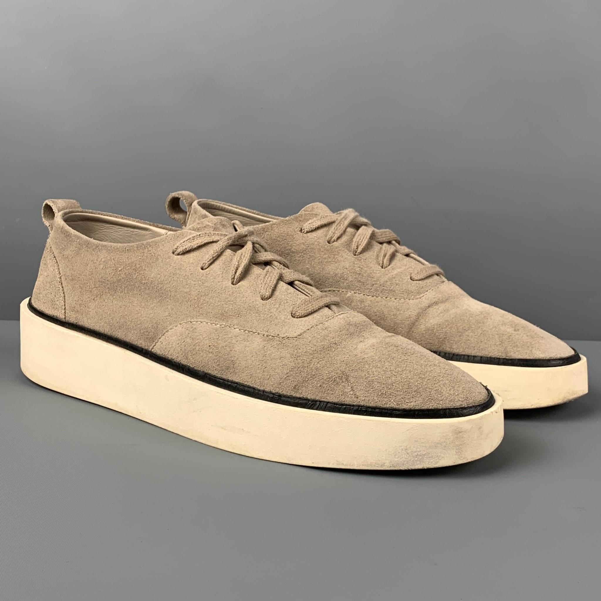 FEAR OF GOD sneakers comes in a light grey textured suede featuring a low-top style, black trim, and a lace up closure. Made in Italy. 

Good Pre-Owned Condition.
Marked: 44

Outsole: 12 in. x 4 in.  