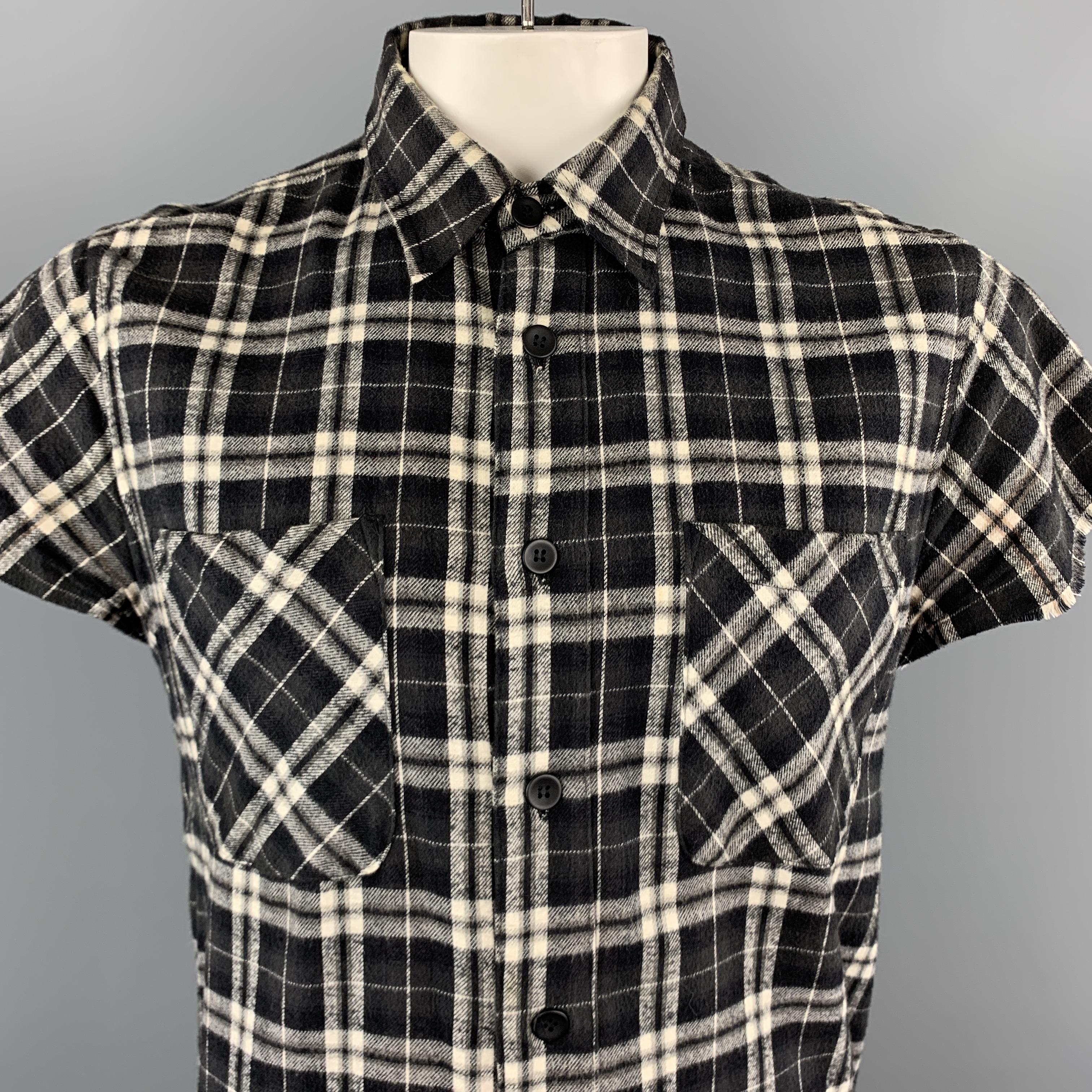 FEAR OF GOD Third Collection 2014-2015 flannel comes in black and white plaid cotton wool blend tartain with a pointed collar, double patch breast pockets, raw edge cropped sleeves, and side zips. Made in USA.

Excellent Pre-Owned Condition.
Marked: