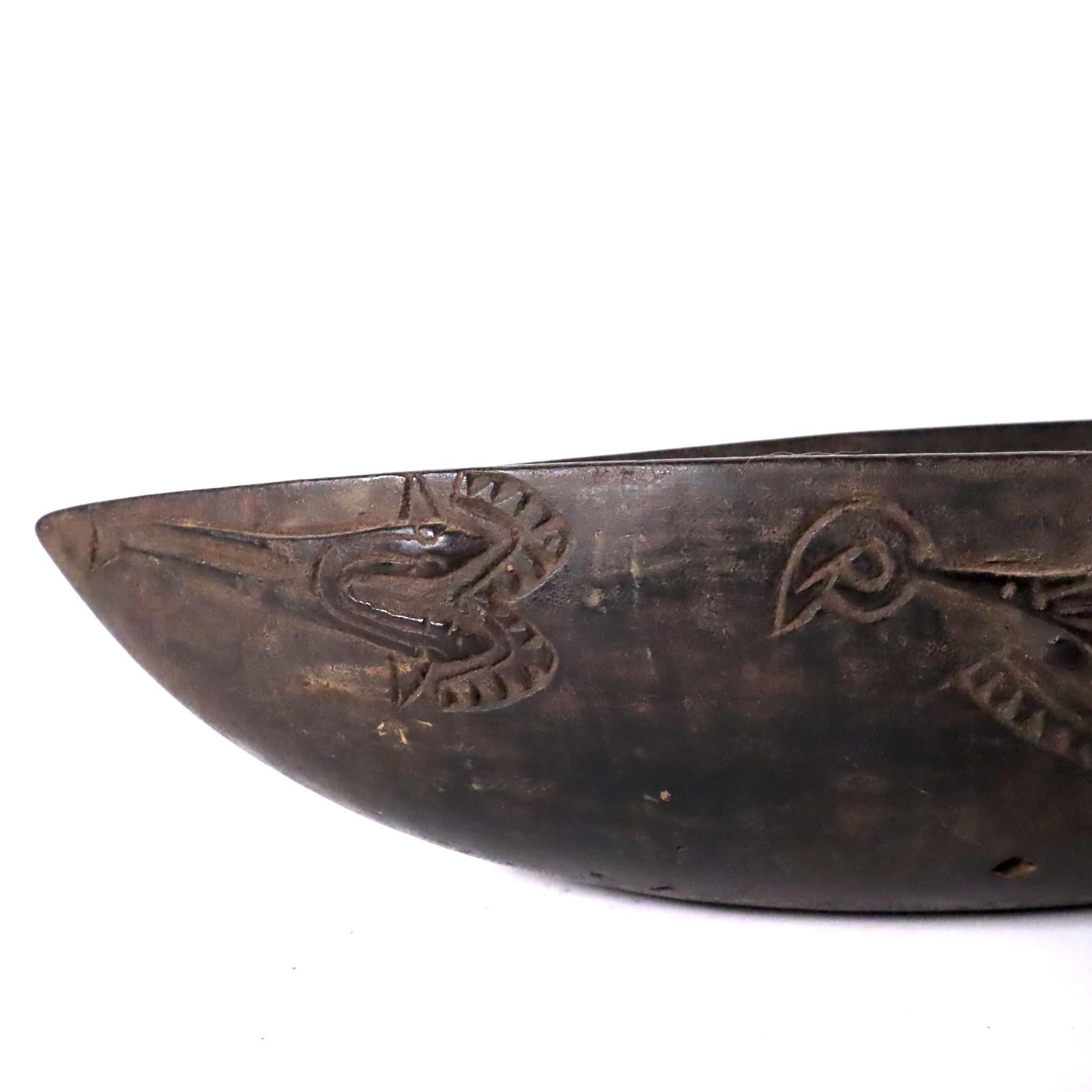 Store closing March 31 Last chance clearance sale.  Feast bowl, carved wood with black patina. From the Massim region off the East Coast of Papua New Guinea. Probably created in the early to mid-20th century for use as a serving bowl at