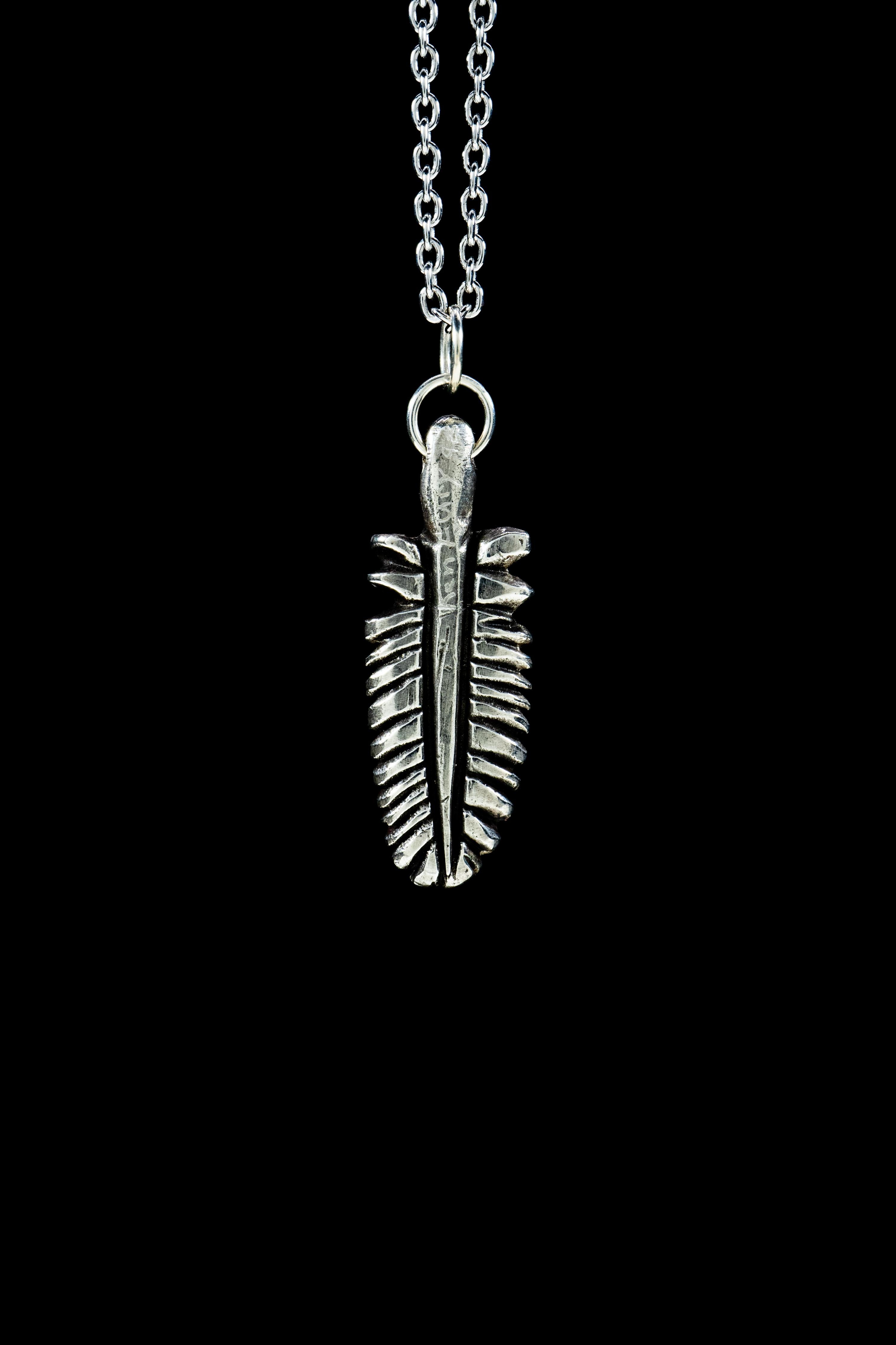Feather is a hand-carved and cast pendant by Ken Fury.

Available in 14K White Gold.

Pendant size: 13mm x 31mm 

Hand-signed

Includes a 20-inch sterling silver chain.
