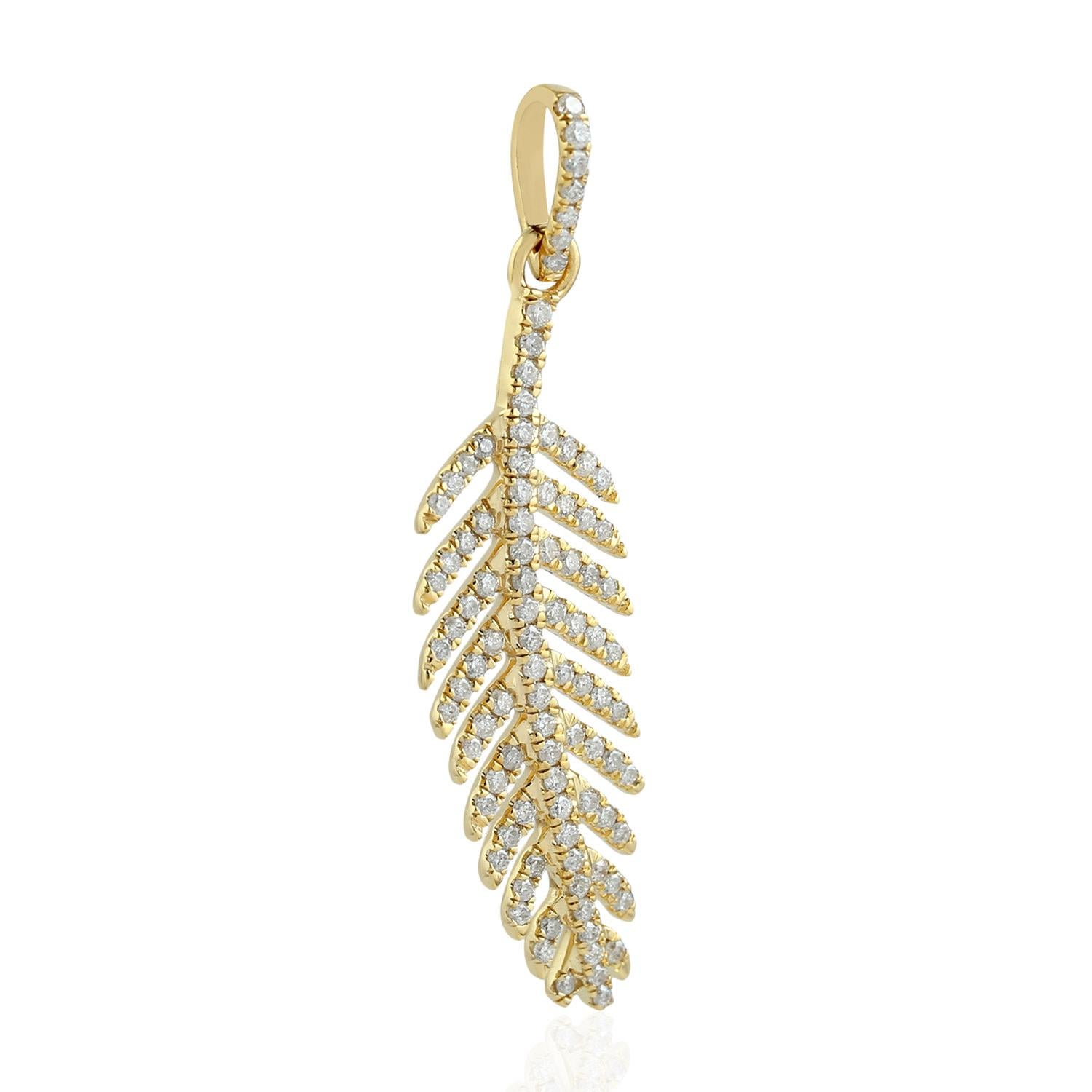 This 14 karat gold pendant is set with .47 carats of shimmering diamonds. 

Feathers are a symbol of freedom because they are associated with wings and birds.  Birds are free to fly and they represent freedom.  They fly and glide peacefully in the