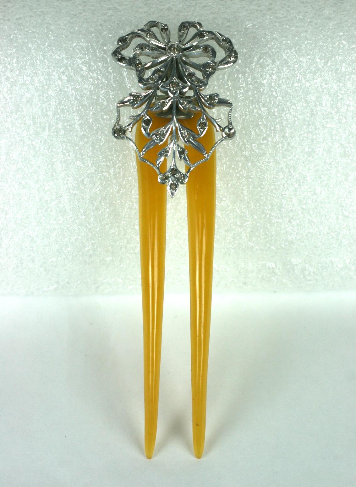 Victorian Aigrette Hair Comb of early bakelite, made to resemble blond horn with a pierced white metal motif set with pastes. 
A tube on the hinged motif allows for the addition of a feather(s).
Circa 1900 USA. Unusual and charming feminine