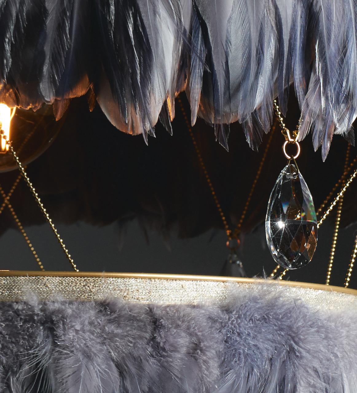 The Bertie is a tactile feather chandelier that we hand make to order from for you in our London studio. Soft and textured, smooth and fluffy; super-soft feathers contrast with the brass accents of cool ball chain. The faceted crystal drops