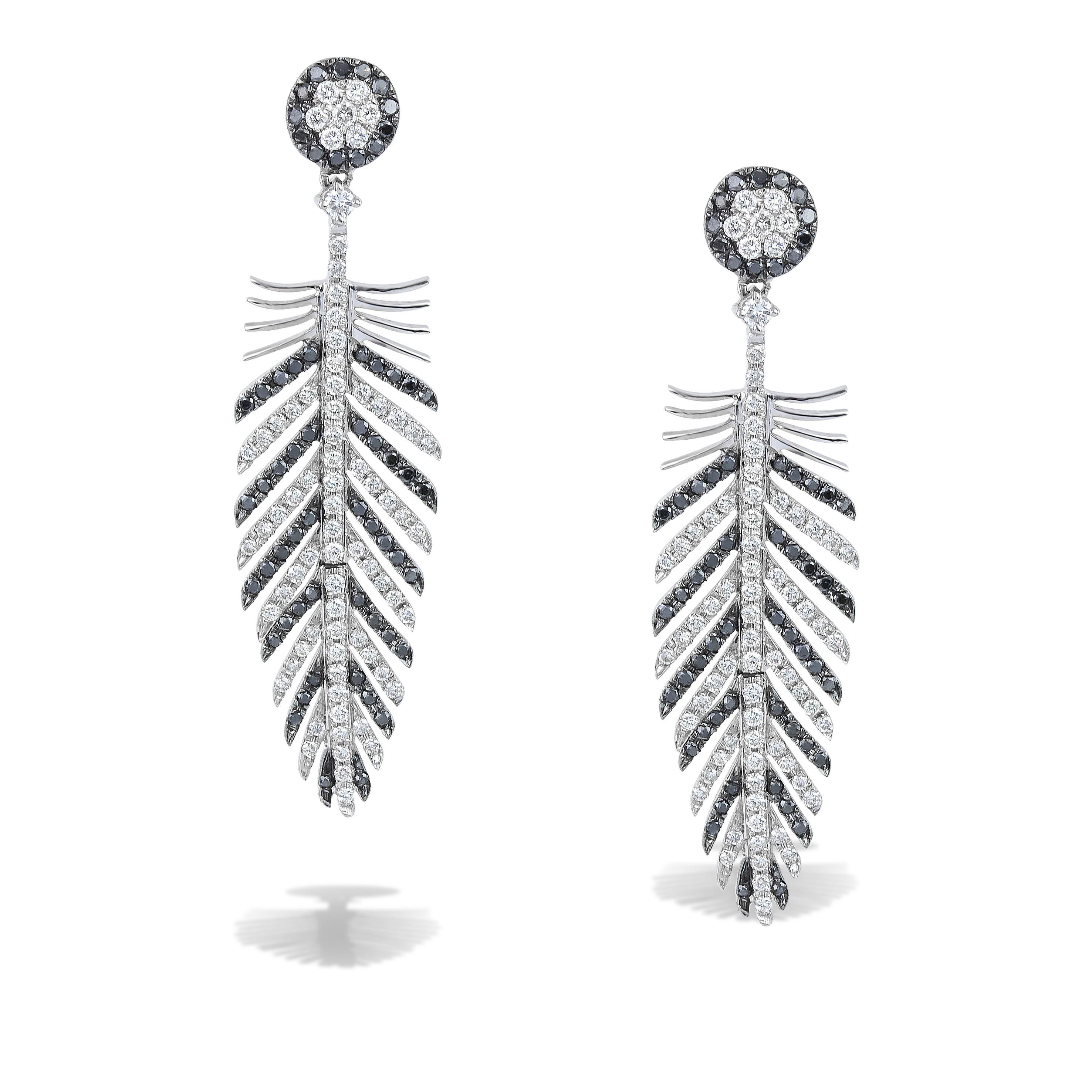 Feather Wing Chandeliers pair of earrings with black and white diamonds 2.57 ct ,handcrafted in 18Kt white gold. The white diamonds contrast sharply with the black ones, reflecting and absorbing the light. This One-Of-A-Kind pair of earrings belongs