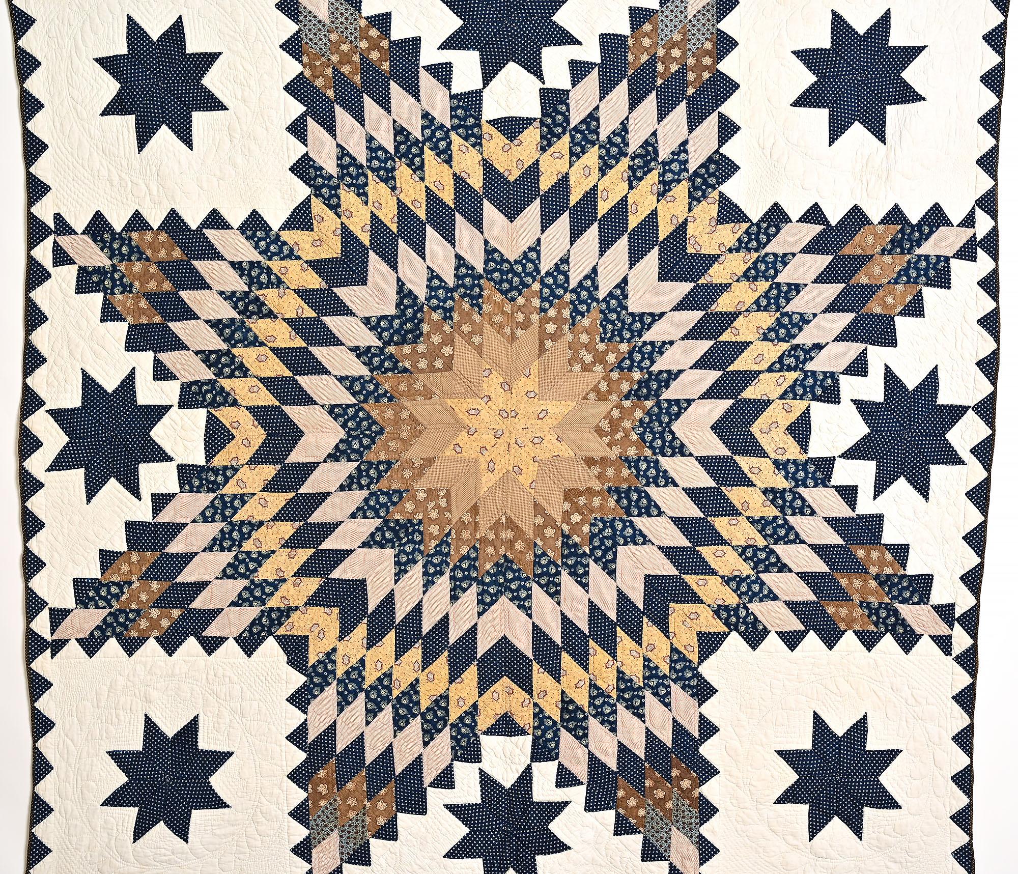 This is a dramatic and unusual variation of a Lone Star Pattern. The triangles, or feathers, around each arm of the star is an unusual feature that makes the quilt appear to pulsate. A quilted wreath frames each of the LeMoyne Stars. Many quilting