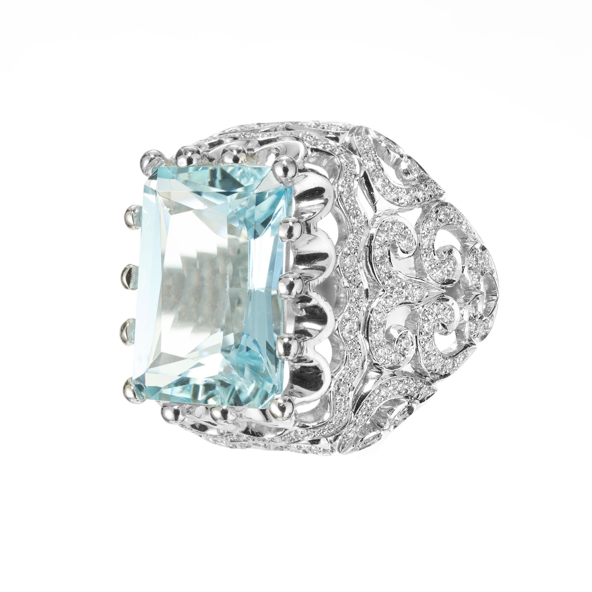 Aqua and diamond ring. Beautiful bright prodigious 6.64 carat emerald cut center Aquamarine mounted in a platinum open work artisan cocktail setting, accented with 150 round cut pave set diamonds. By New York designer Featherstone.

1 rectangular