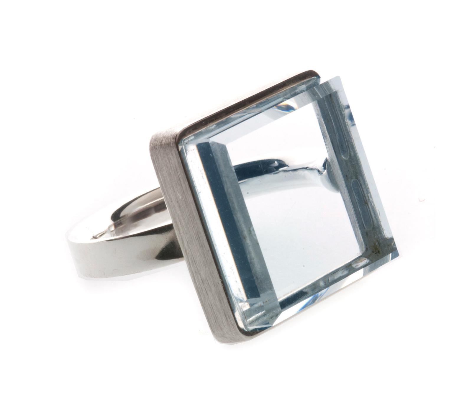 This contemporary jewellery ring features a 15x15x8 mm light blue quartz set in 14 karat yellow gold. It has been featured in Harper's Bazaar and Vogue UA publications.

The ring exudes an art deco spirit and is suitable for both women and men. It