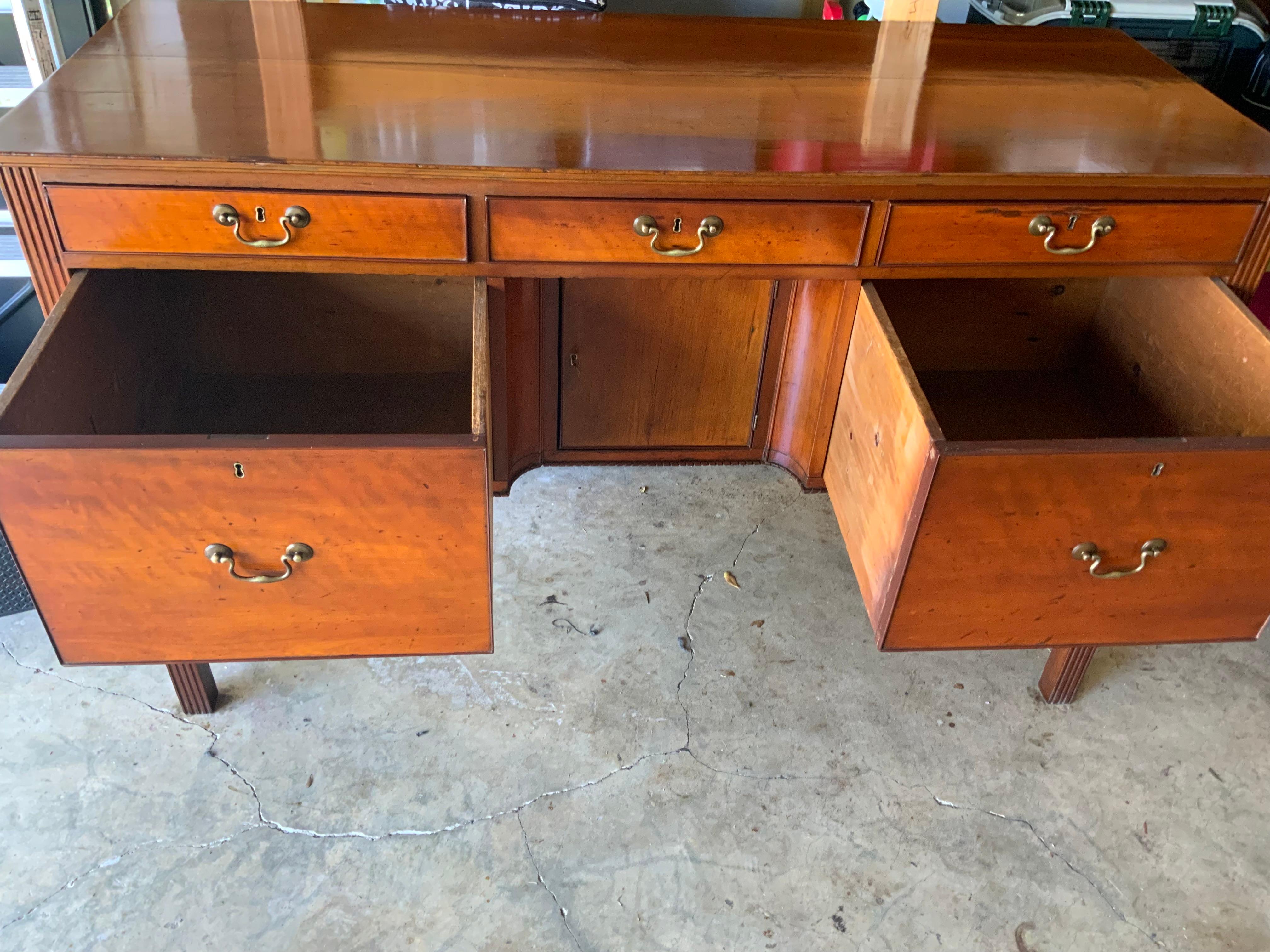  American federal Cherry Huntboard or 1800-1820 on carved concave fluted legs.  One center door storage compartment between two large deep drawers on either end under a bank of three smaller drawers, two of which have been previously lined with