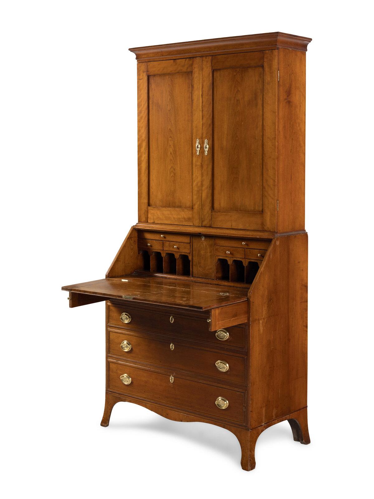 This Federal Cherrywood Bureau cabinet dates to 1790.  It is a beautifully preserved example of early American Federal craftsmanship.  The piece combines graceful proportions, warm patinated surfaces, and practical interior storage--embodying both