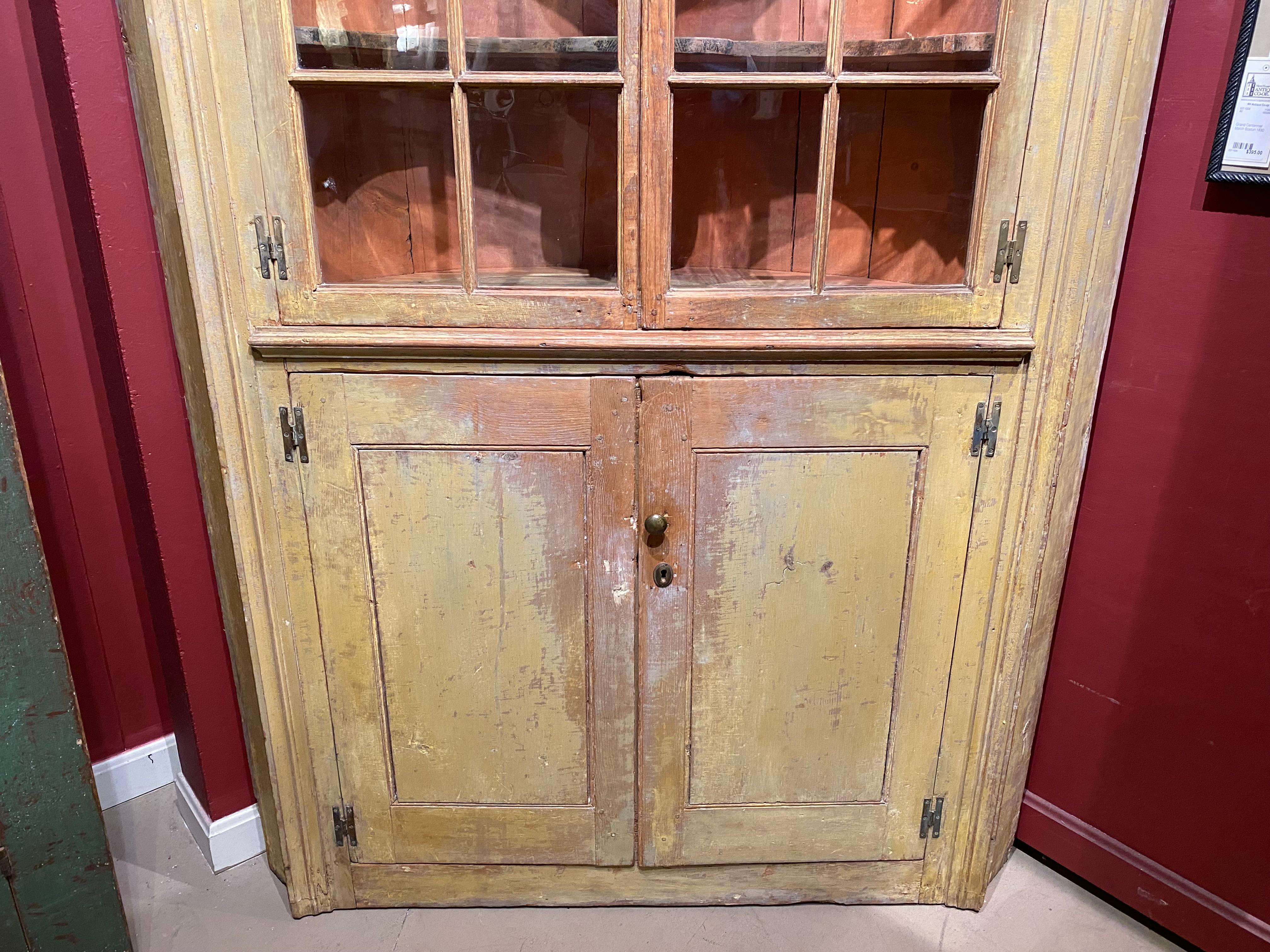 Hand-Carved Federal Corner Cupboard in Early Yellow Paint with Glazed Doors & Barrel Back For Sale