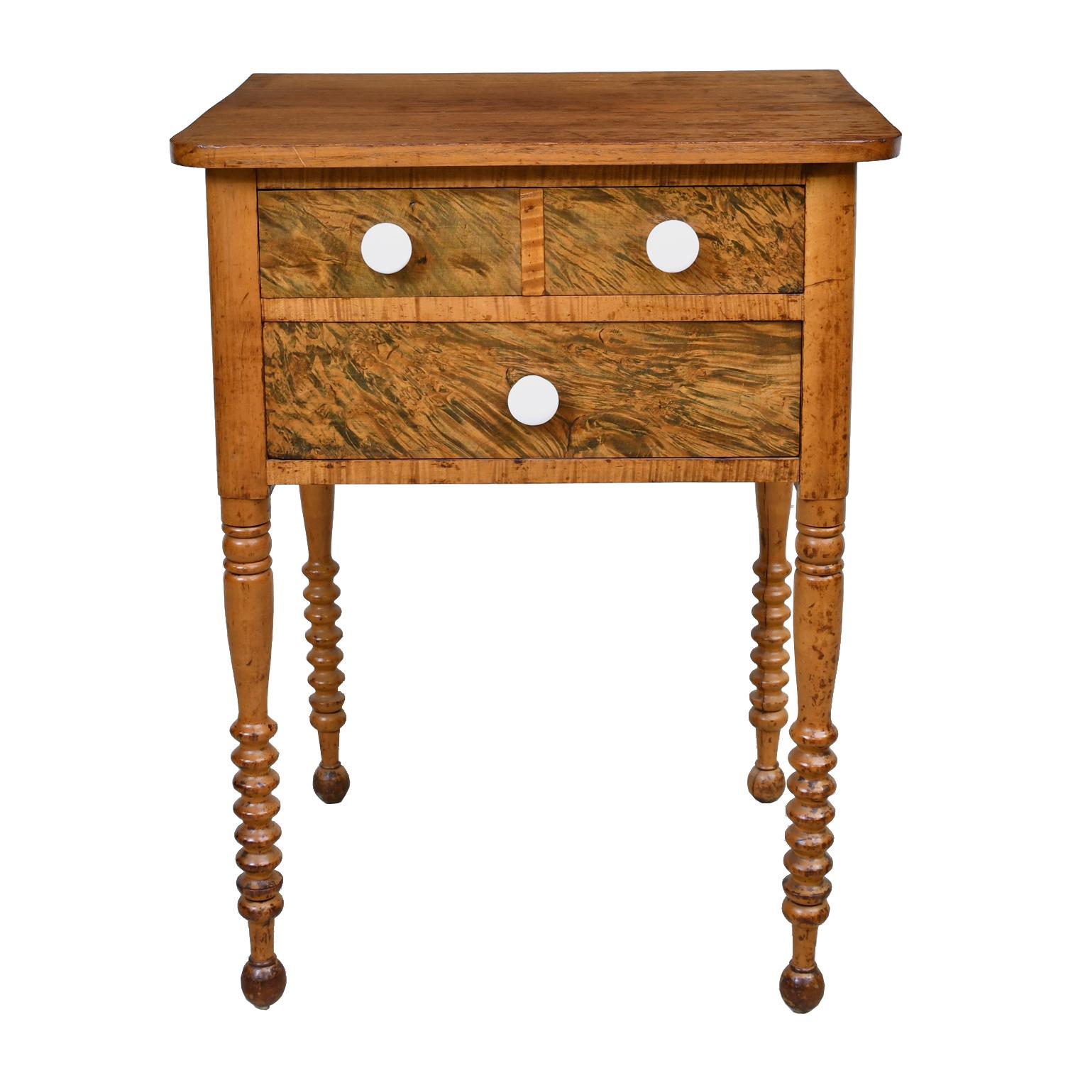 A small and well-proportioned federal table in beautiful fruitwood on turned legs that end in spool turnings, and offering two drawers with white porcelain pulls, Pennsylvania, circa 1820.
Measures: 23