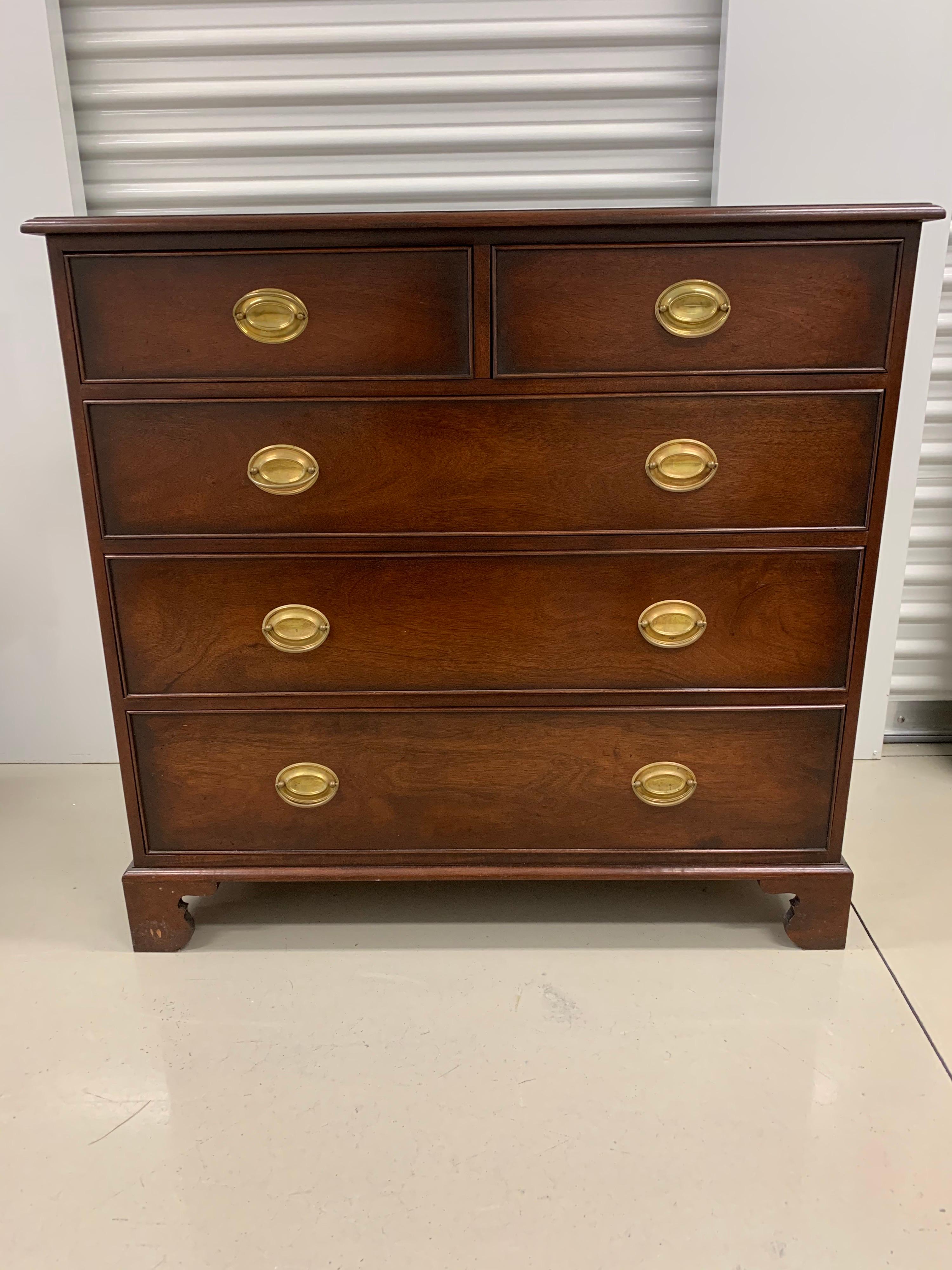 Elegant mahogany chest of drawers with original brass oval hardware. There are five drawers in
all and great Federal style lines. See dimensions, not too big and not too small.