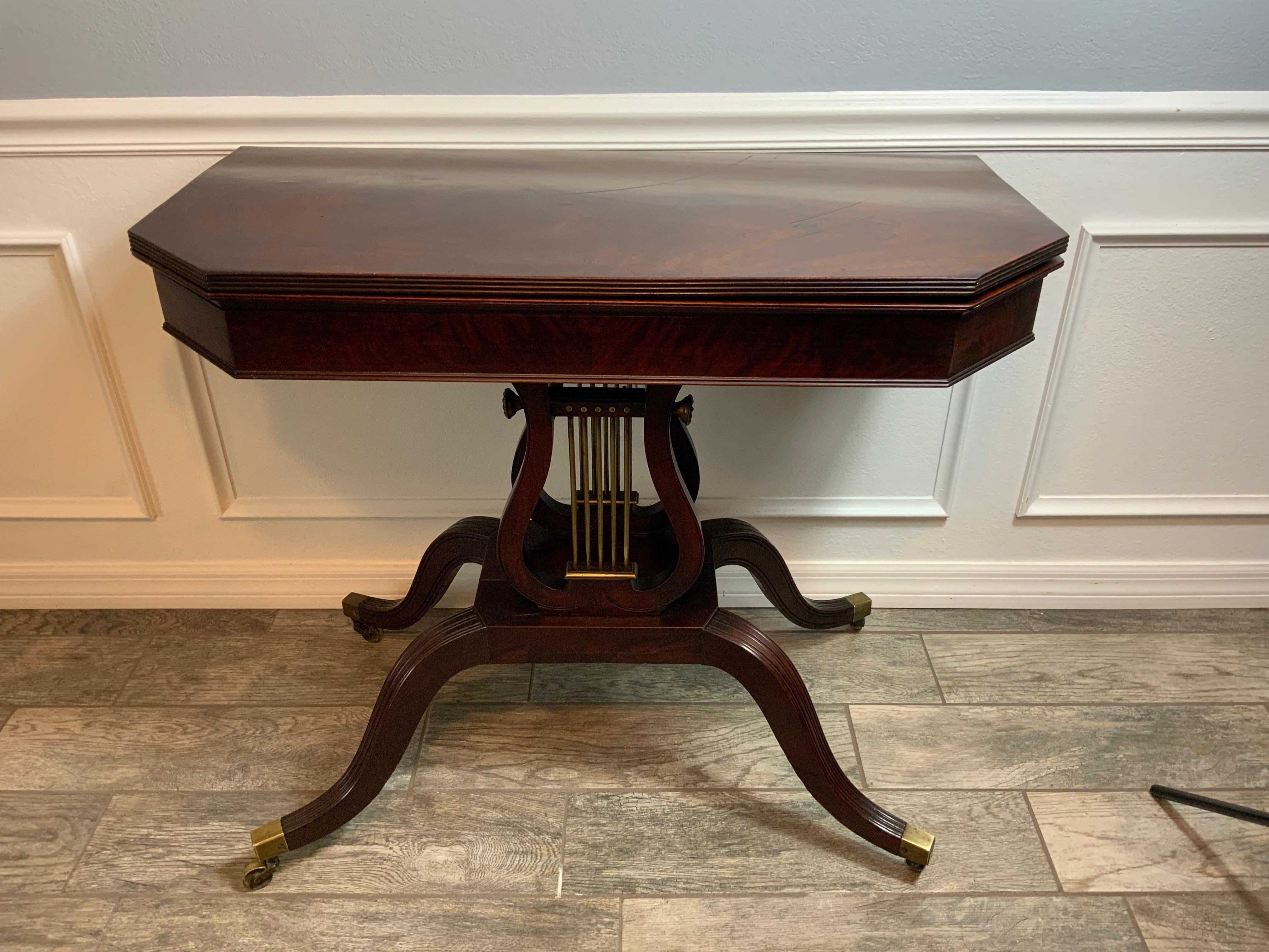 A very nice Federal  Mahogany Lyre / harp base card table 1800-1815.  Original surface with an excellent color and patina on the nicely figured solid Cuban Mahogany one board canted corner reeded edge tops..  White pine secondary case wood under the