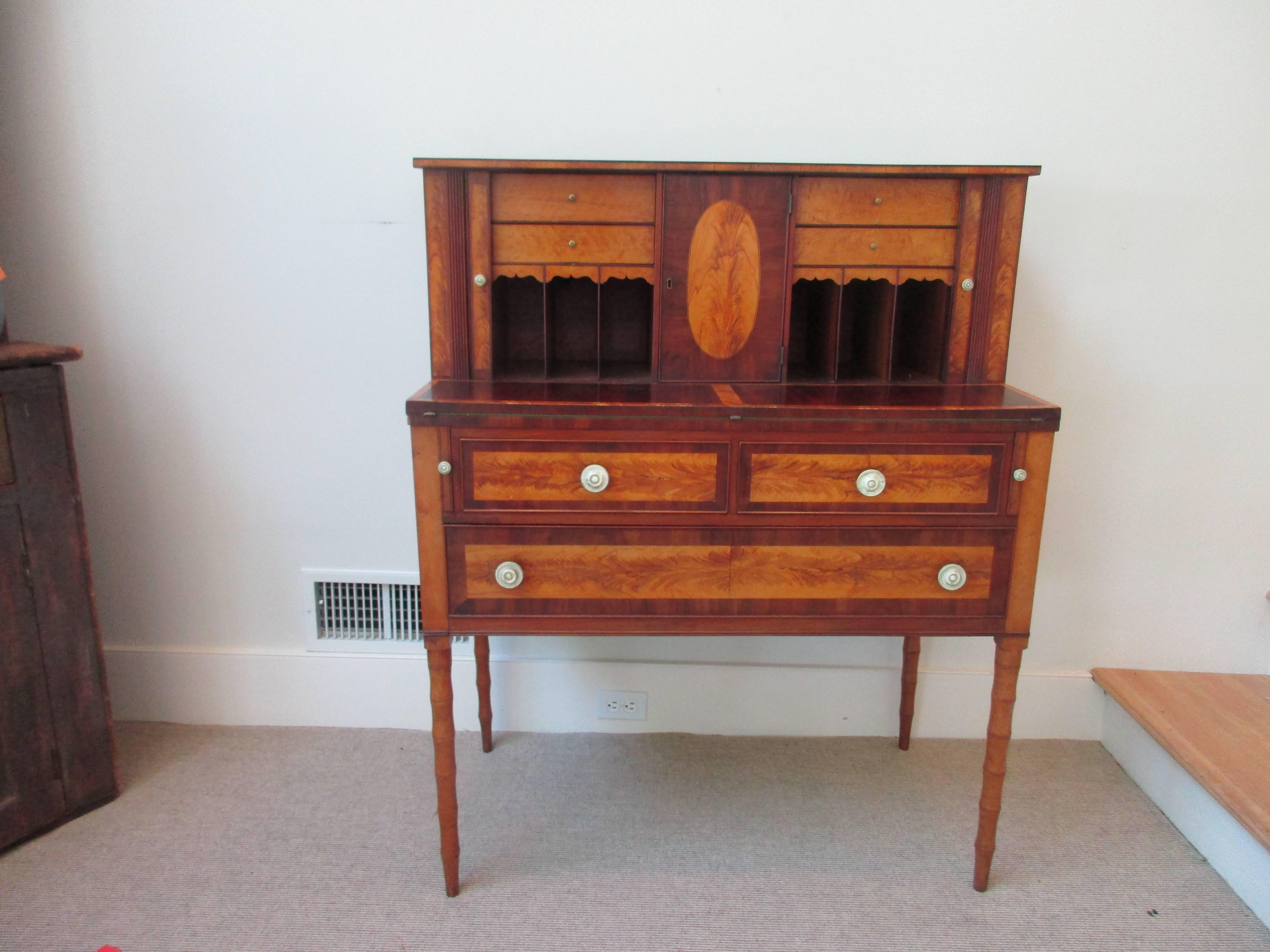 Federal Mahogany and Birch inlaid secretary/desk with contrasting veneers and
bone pulls.