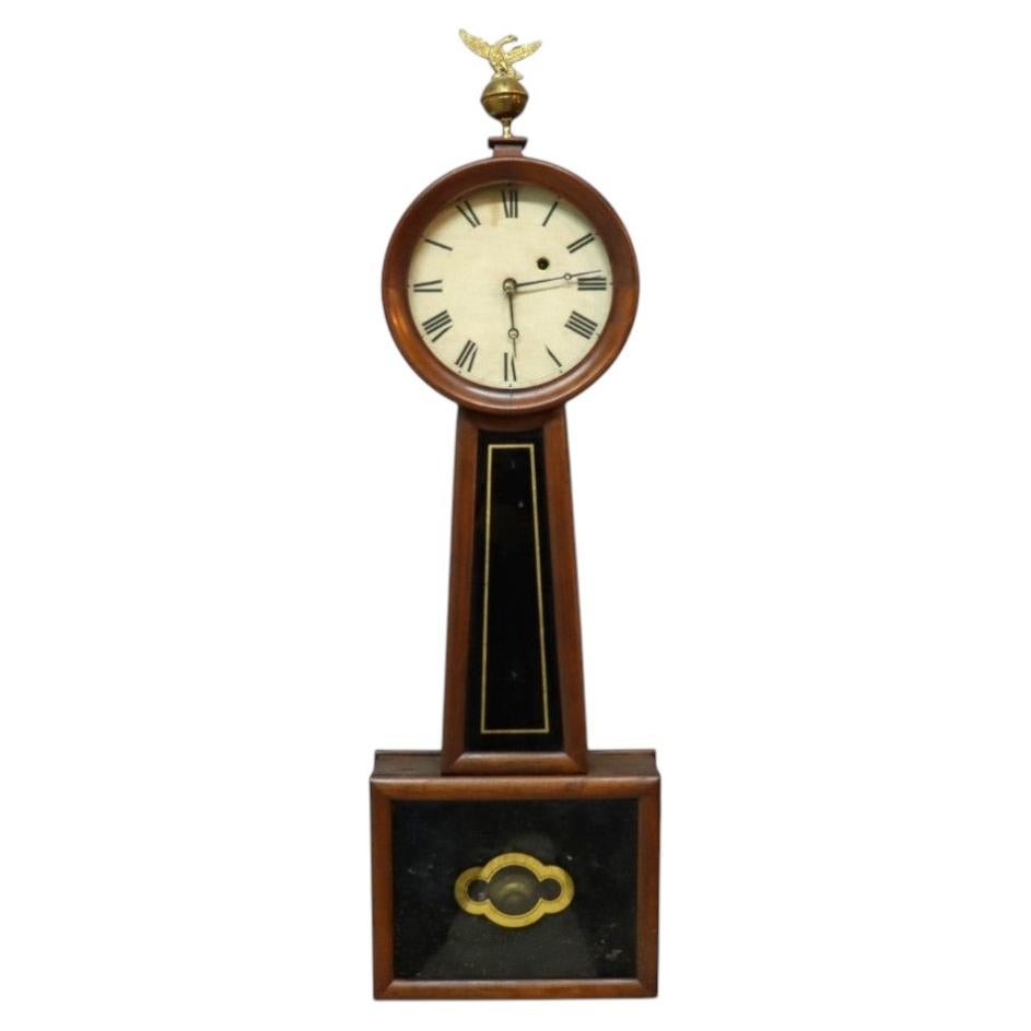 How do I wind a banjo clock?
