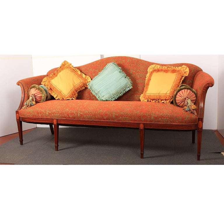 A fine Federal mahogany inlaid sofa with an arched camel back, with scroll arms on six legs, the beautifully upholstered cushion backrest, seat, and arms are in wonderful, clean, ready-to-use condition. The arms with bellflower inlays and legs with