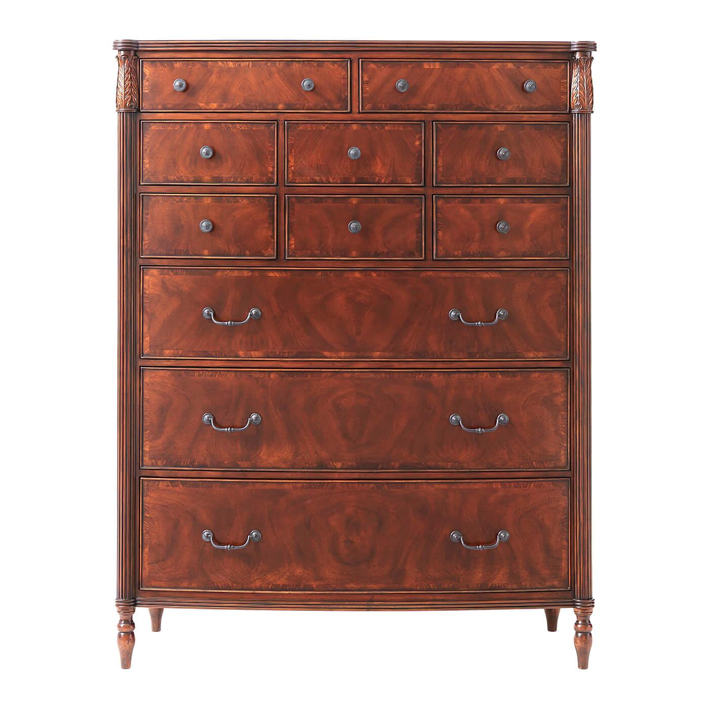 A Federal style mahogany and figured mahogany Gentleman's chest of drawers, the bowfront reeded edge top with protruding corners above leaf carved capital and reeded column supports, with an arrangement of eight short drawers and three long