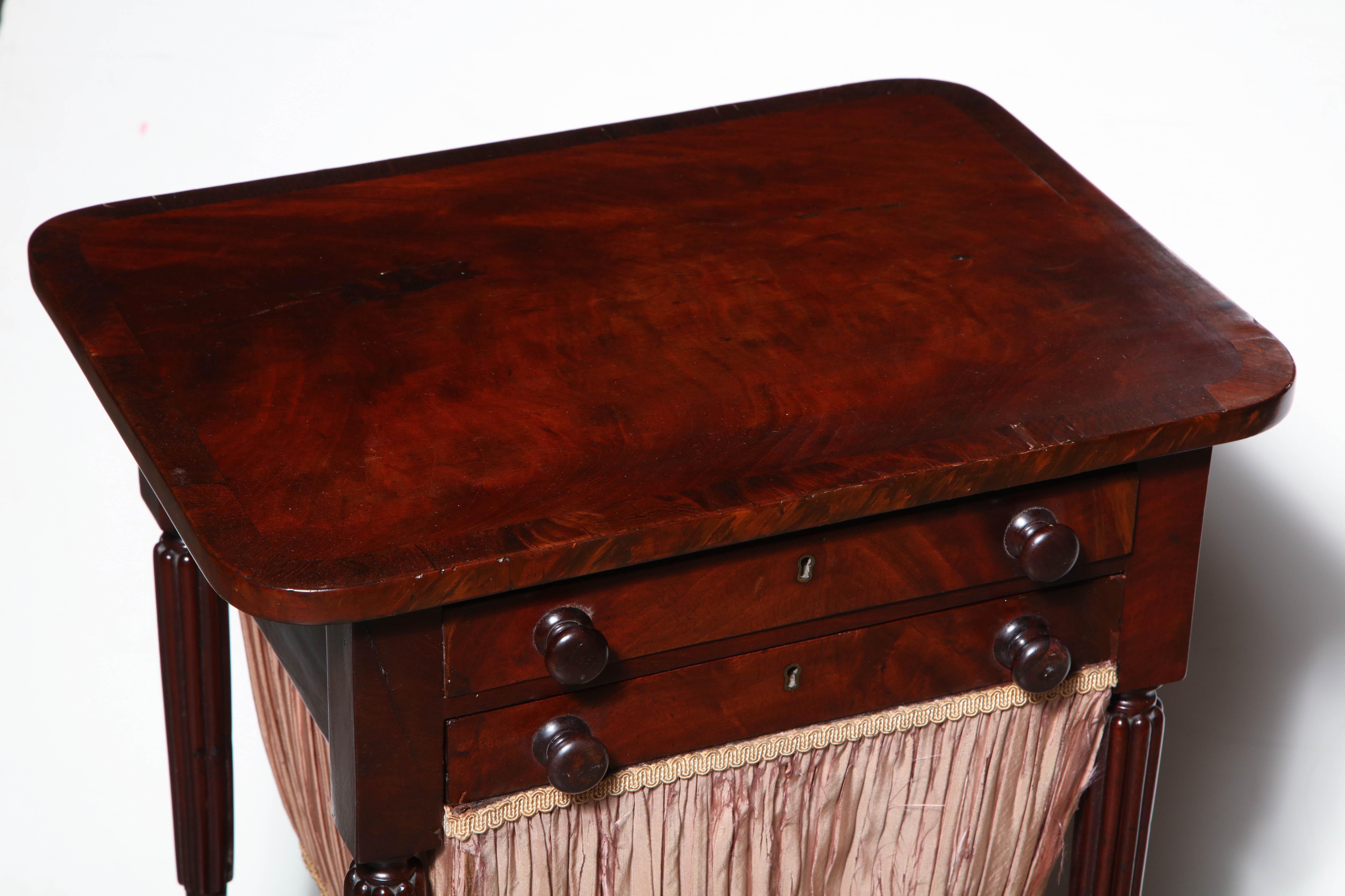 A fine American Federal reed leg mahogany cross banded worktable with fitted top drawer and sewing bag drawer.