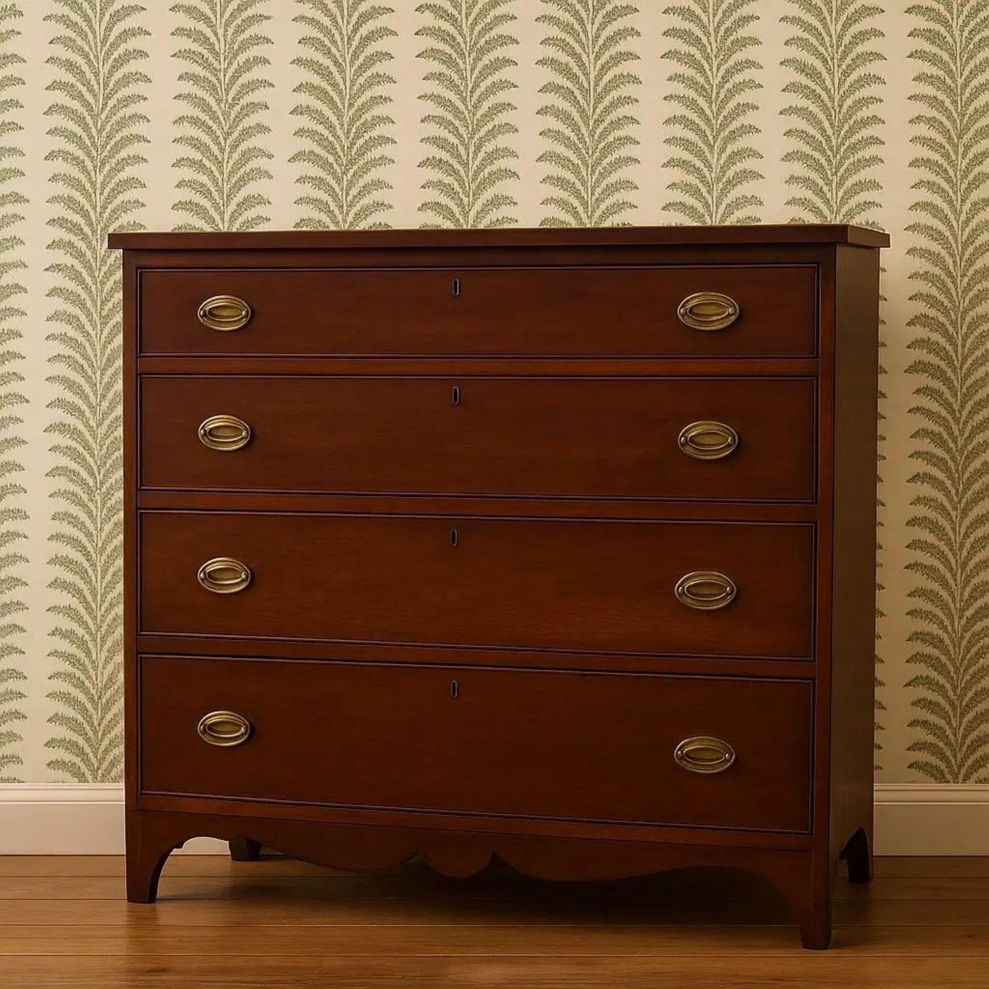 This elegant antique chest of drawers dates to the late 18th to early 19th century and reflects strong Hepplewhite and early Federal influence, a refined American furniture style prized for its clean lines and graceful proportions. Crafted in richly