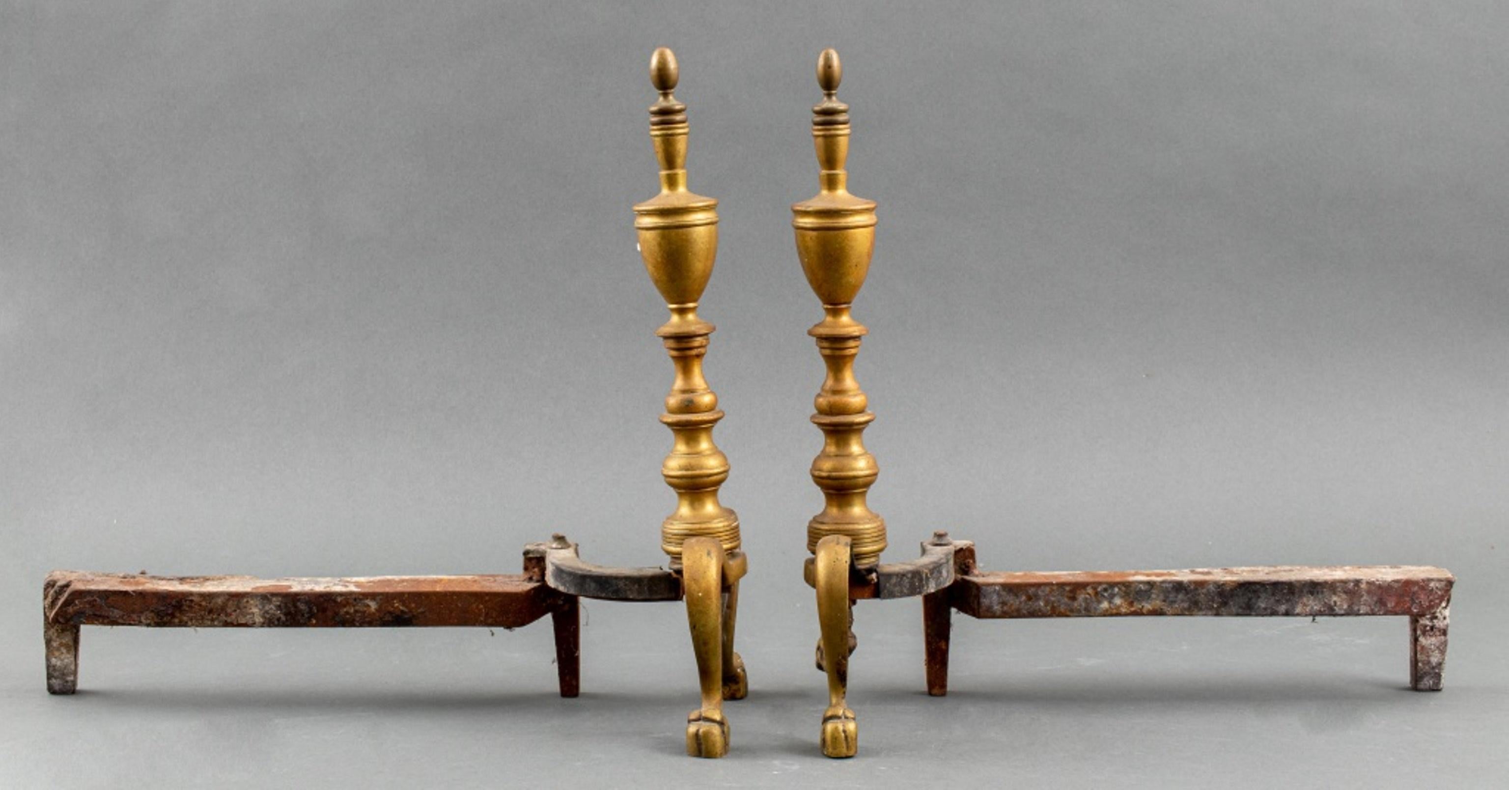 Federal style brass andirons in the colonial taste with urn-shaped finials above a turned shaft on two cabriole legs terminating in stylized lions' feet. In very good vintage condition. 

Dealer: S138XX.