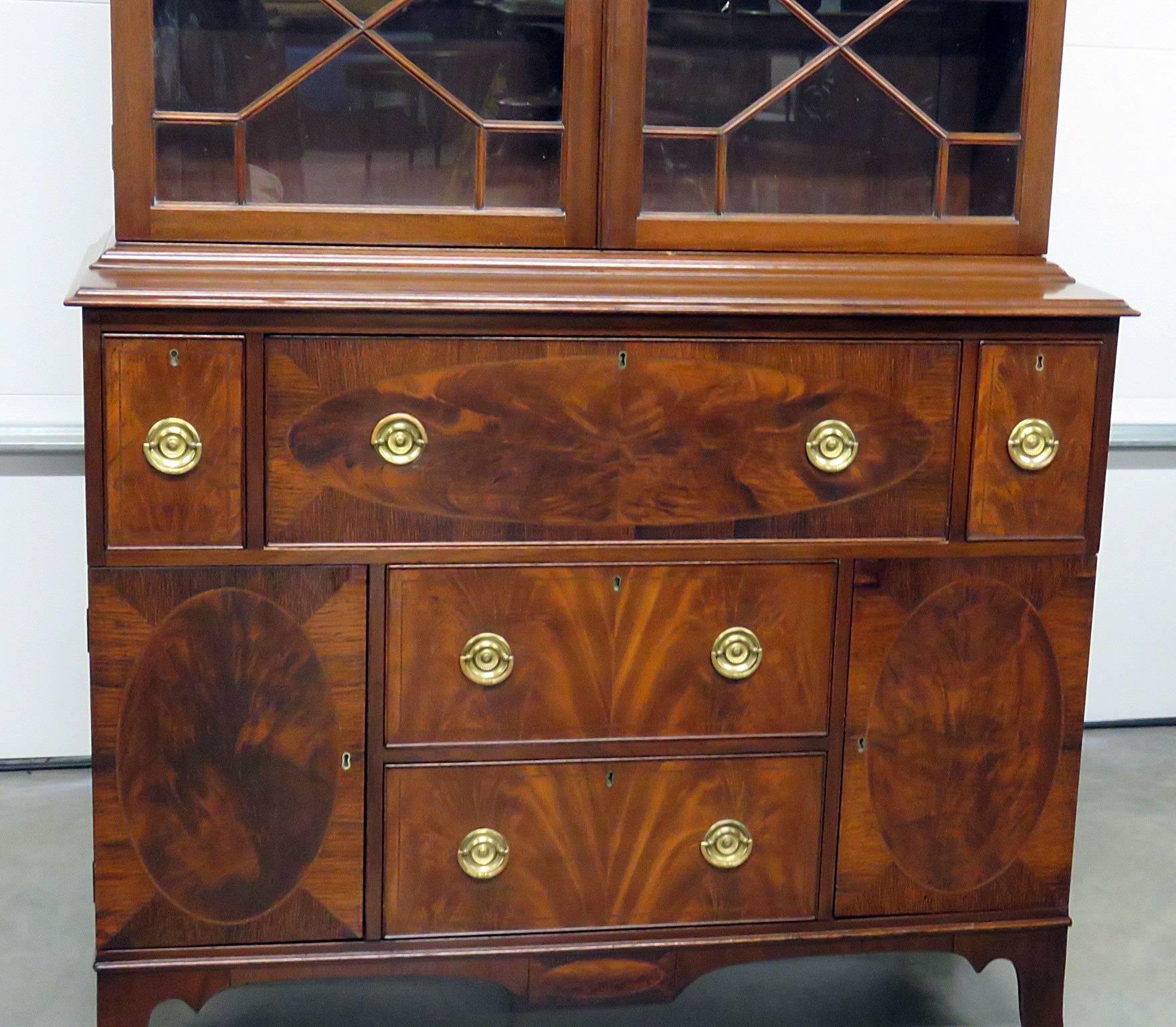 Federal style inlaid china cabinet with two upper doors and two shelves. The bottom section has five drawers and two doors.