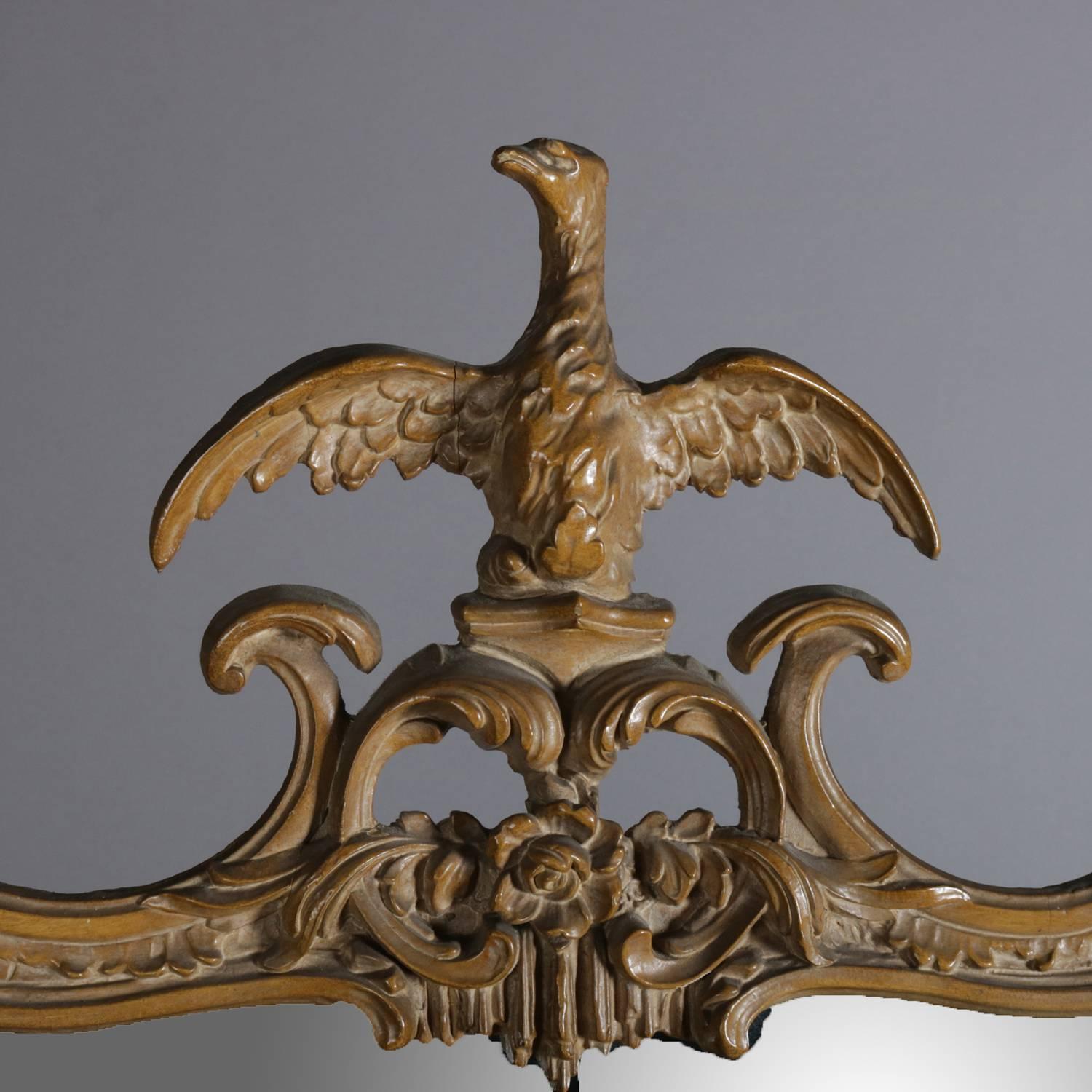 Federal style figural wall mirror features carved and painted frame with spread eagle phoenix on pierced foliate form crest; frame with scroll, floral and foliate form; 20th century

Measures: 45