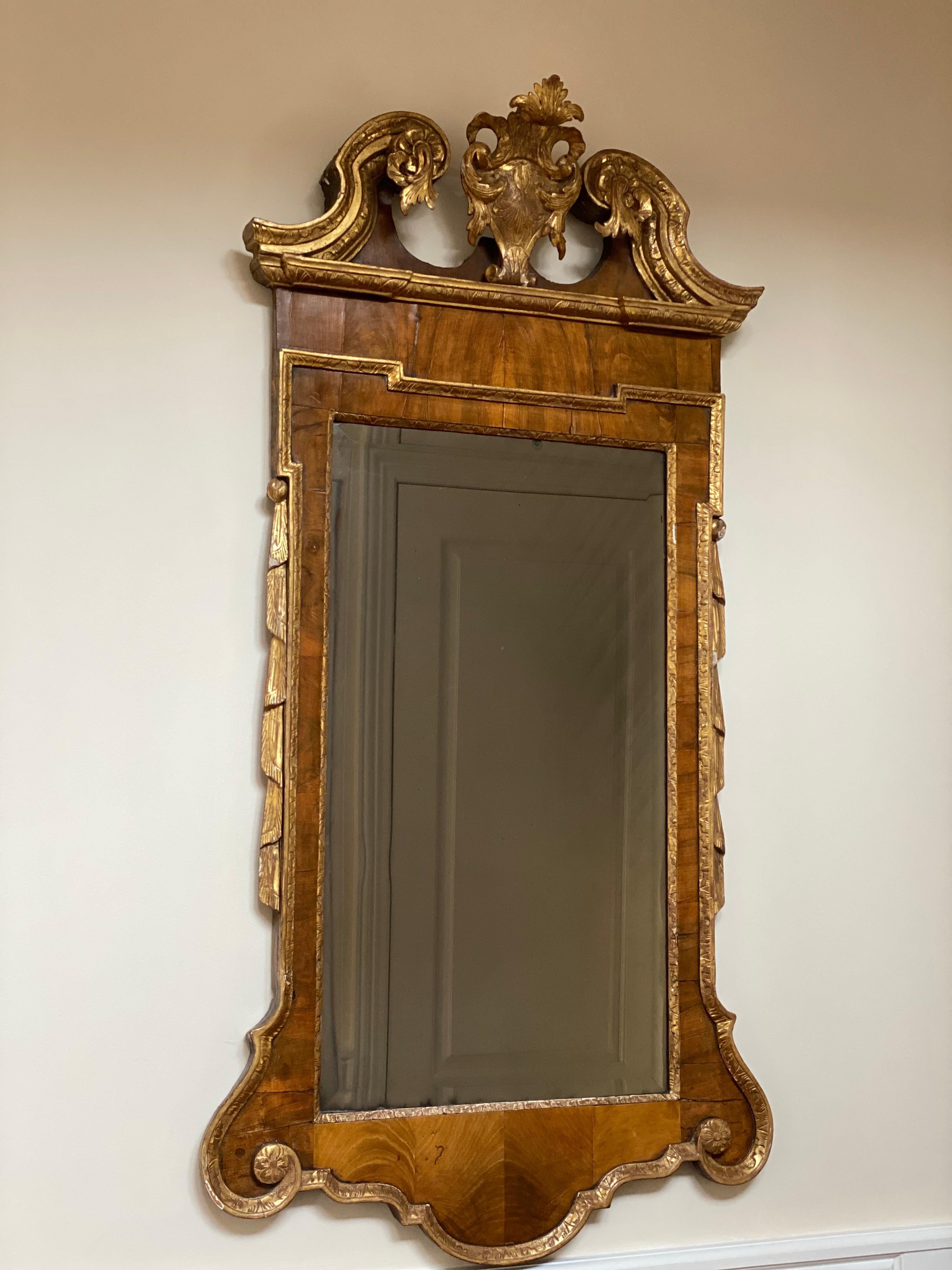 Federal Style Gilded Carved Wood Mirror, 19th Century 

Carved wood American Federal style parcel-gilt wall mirror featuring a broken scroll pediment, solid wood frame, nicely carved details, great style and form. 
May need to be crated to ship