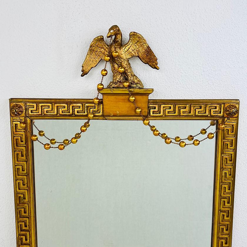 Vintage federal style wall mirror features Greek key bordering terminating in corner rosettes, topped by a spread eagle, and bears the Borghese maker's label en verso, circa 1930. 
Measures: 40.5