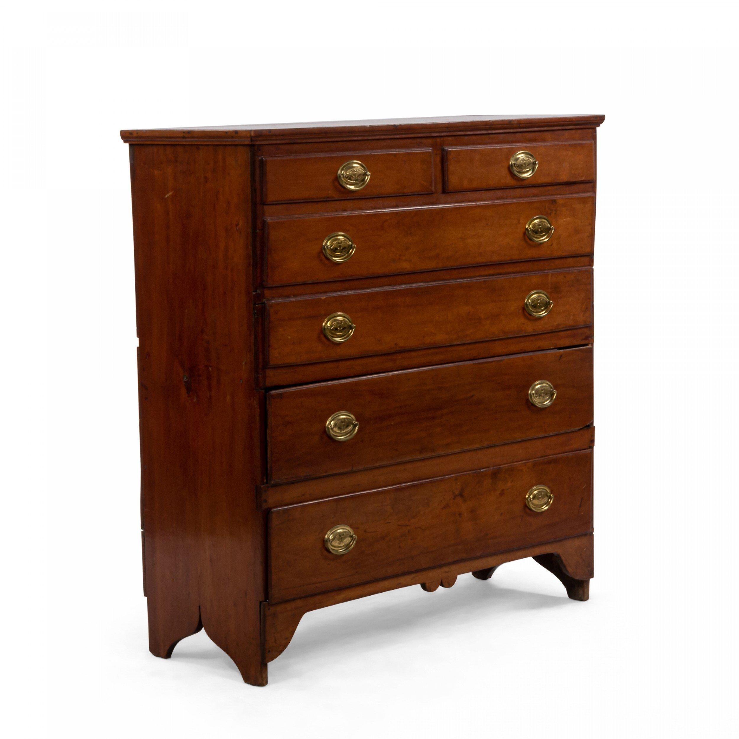 American Federal style 19th century mahogany chest of drawers with 2 lower drawers above dummy drawers having a lift top with replaced brass hardware with an eagle impression supported on bracket feet.
