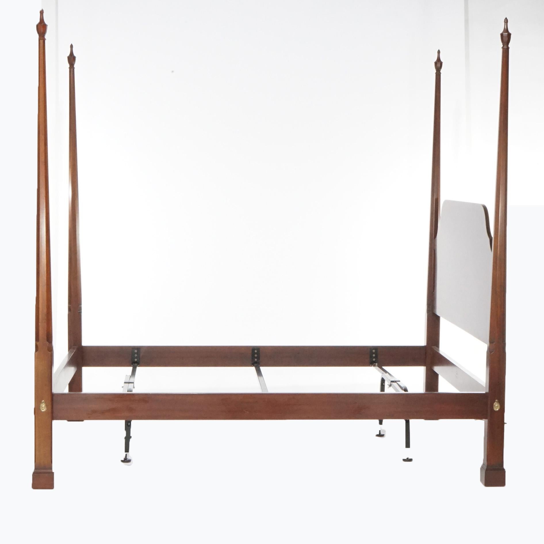 A Federal style queen size bed frame by Henkel Harris offers mahogany construction with turned posts, maker mark as photographed, 20th century.

Measures- 86.75''H x 67.25''W x 87.25''D; Rack is 13.75''H x 61''W x 82''D