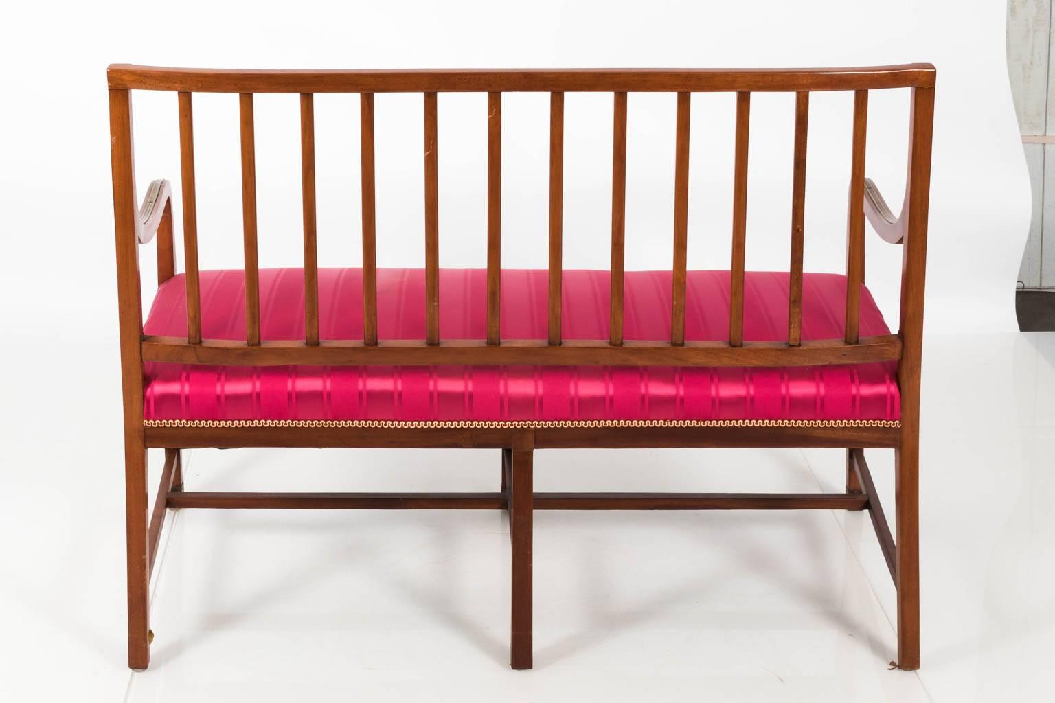 Federal style settee with a straight comb back, custom red upholstery and brass banding throughout, circa 19th century.
 