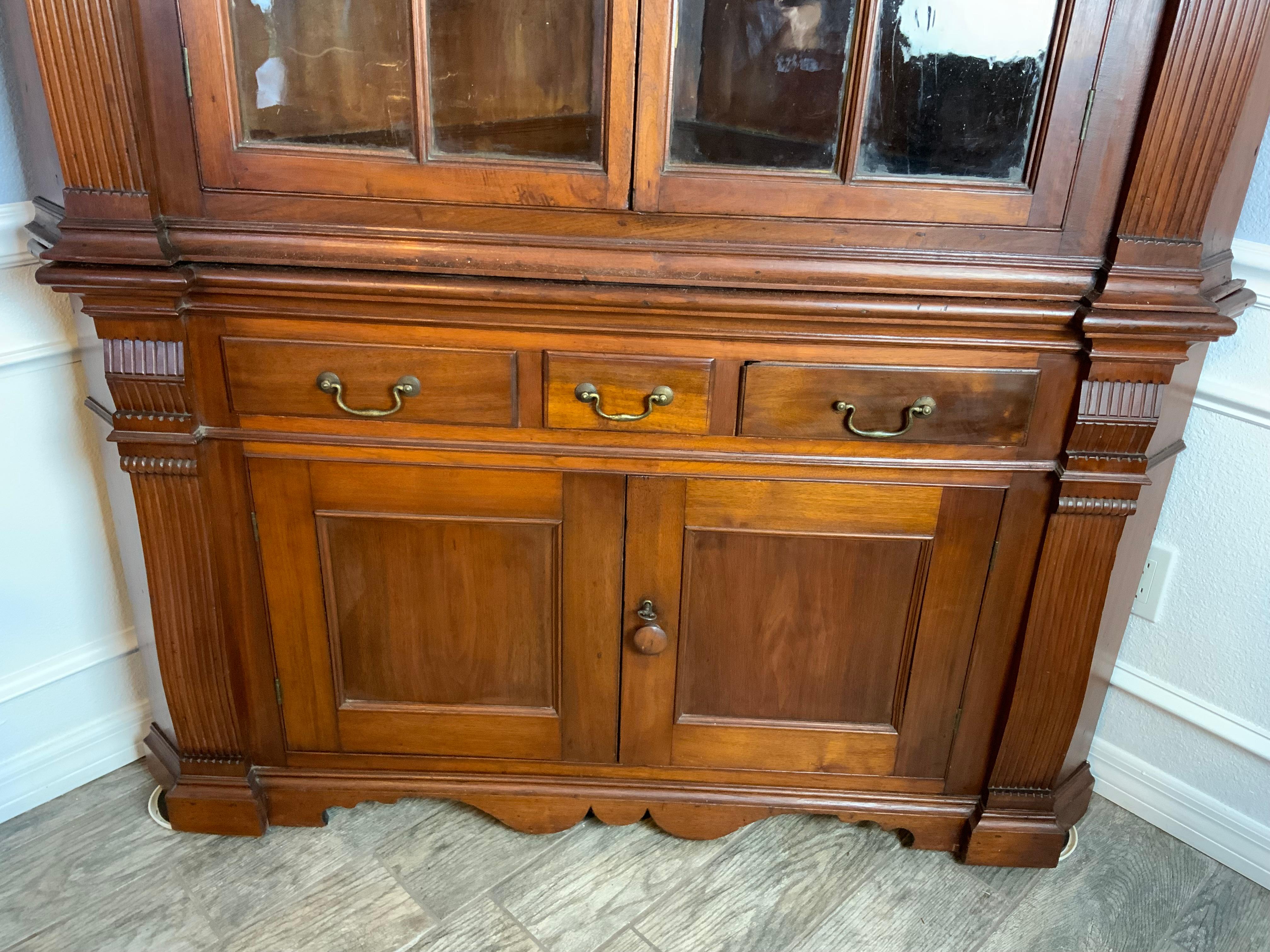 An exceptionally fine large two piece Federal Walnut architectural corner cupboard 1780-1800 attributed to the Frederick County area of Maryland sometime in the third quarter 18th century.  Fluted pilasters, compass-head door aperture with keystone,