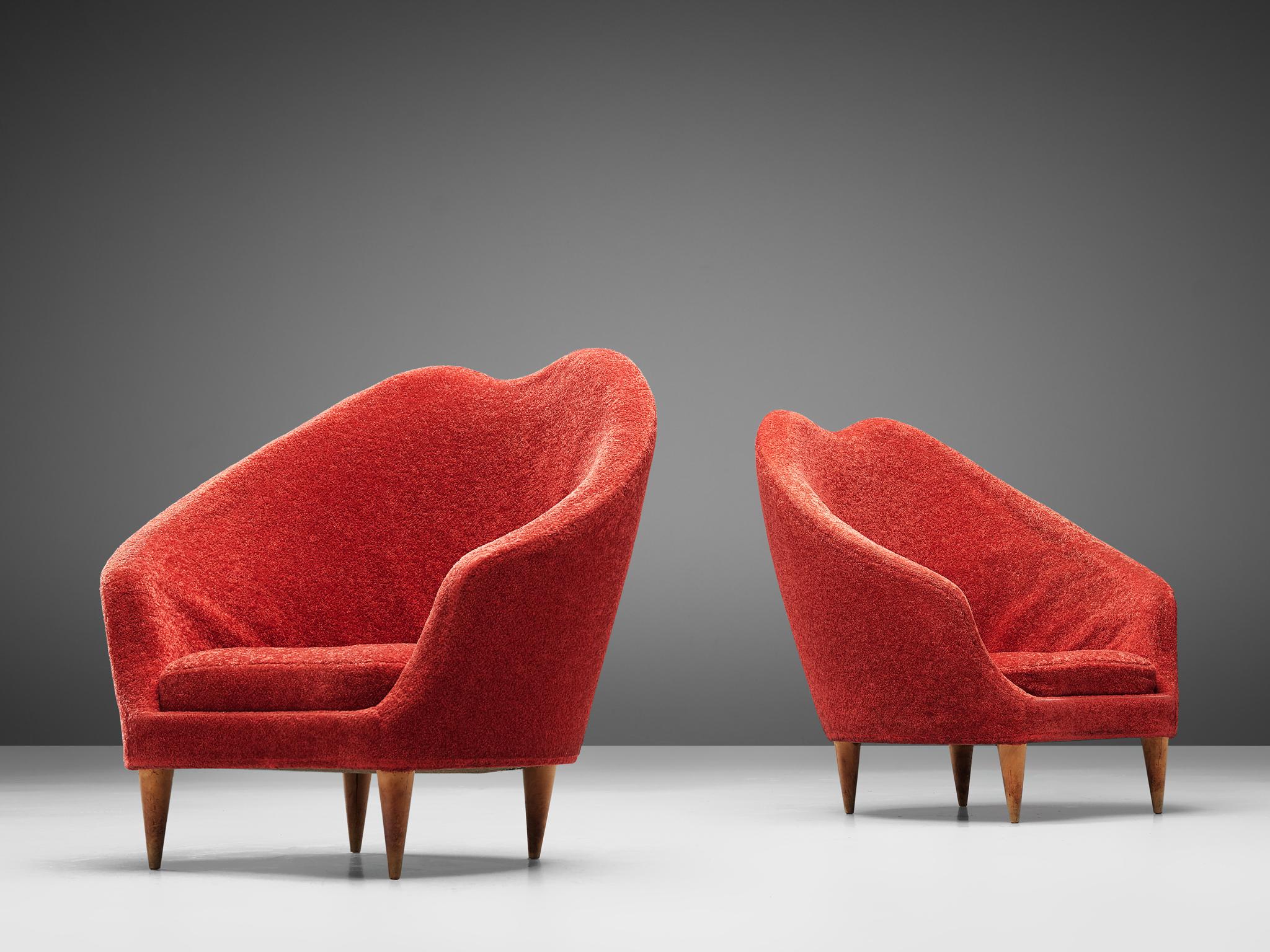 Federico Munari, pair of lounge chairs, fabric and wood, Italy, 1940s.

This theatrical, elegant set of lounge chairs feature a curved, to ascended back that flows over to the armrests. The backrests are bold and high, which gives these chairs