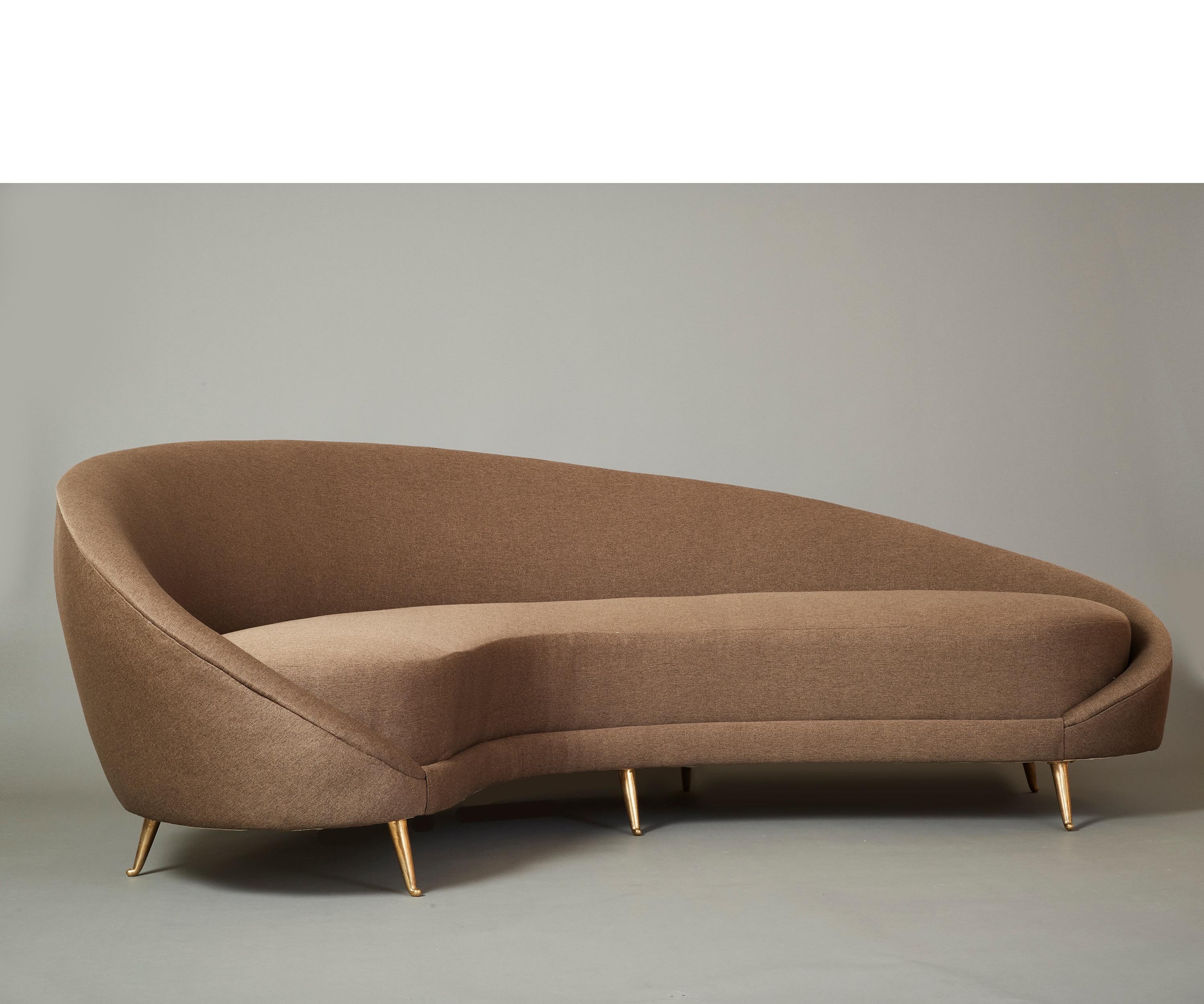 Federico Munari 

A beautifully elongated kidney-shaped sofa by Federico Munari, with serpentine curves. The deep, highly comfortable seat, gracefully sloping back, and tapered arms are raised on handsomely modeled polished brass legs that culminate