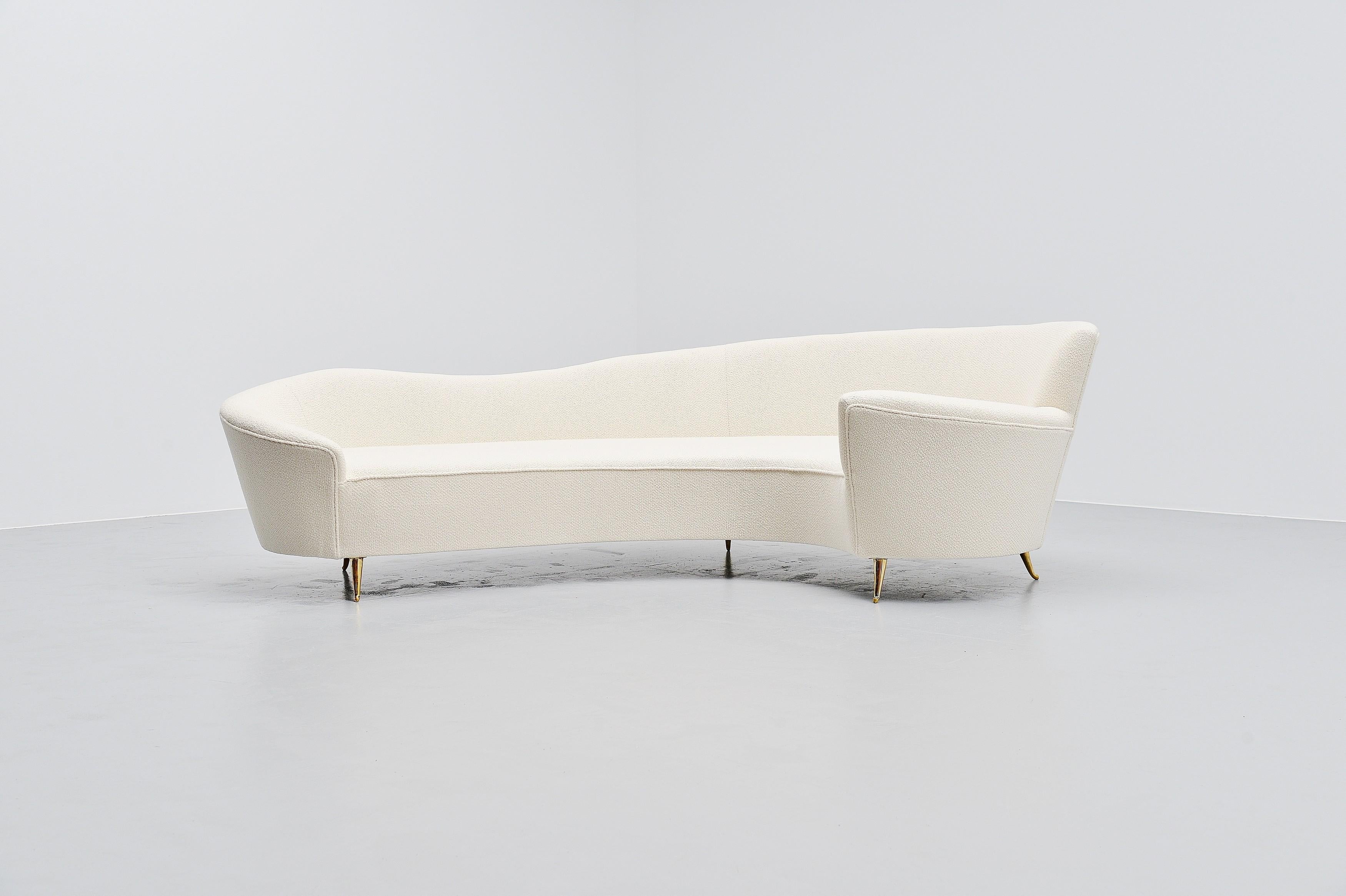 Elegantly curved lounge sofa designed by Federico Munari, Italy 1960. The sofa has a very nice uncommon shape and has solid brass legs. It has solid brass legs and is newly upholstered in very nice white woven fabric. Because of the curved shape,