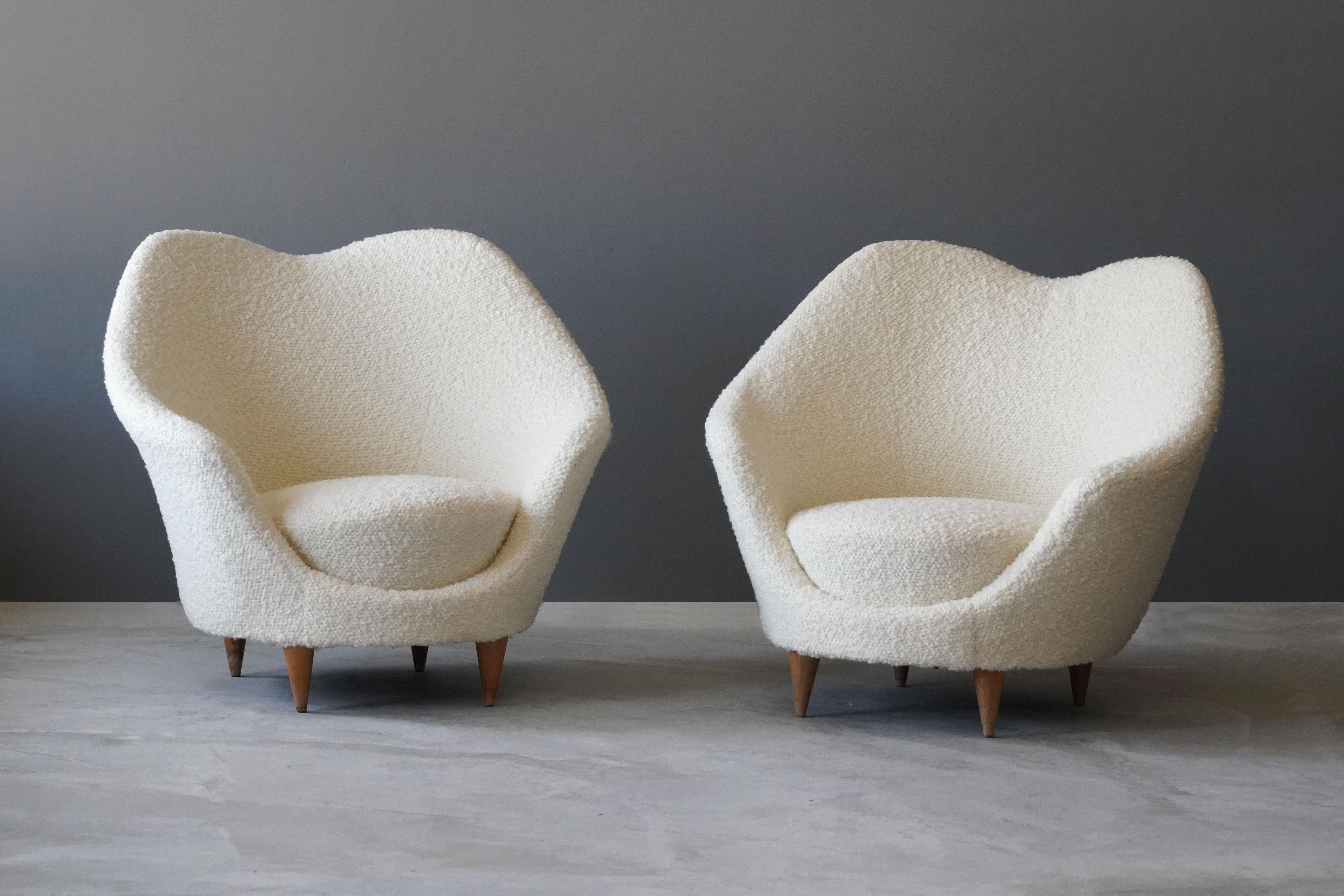 A pair of organic lounge chairs designed by Federico Munari. Produced in Italy, 1950s. Reupholstered in brand new bouclé fabric from Pierre Frey.

Other designers of the period include Gio Ponti, Paolo Buffa, Vladimir Kagan, Ico Parisi and Franco