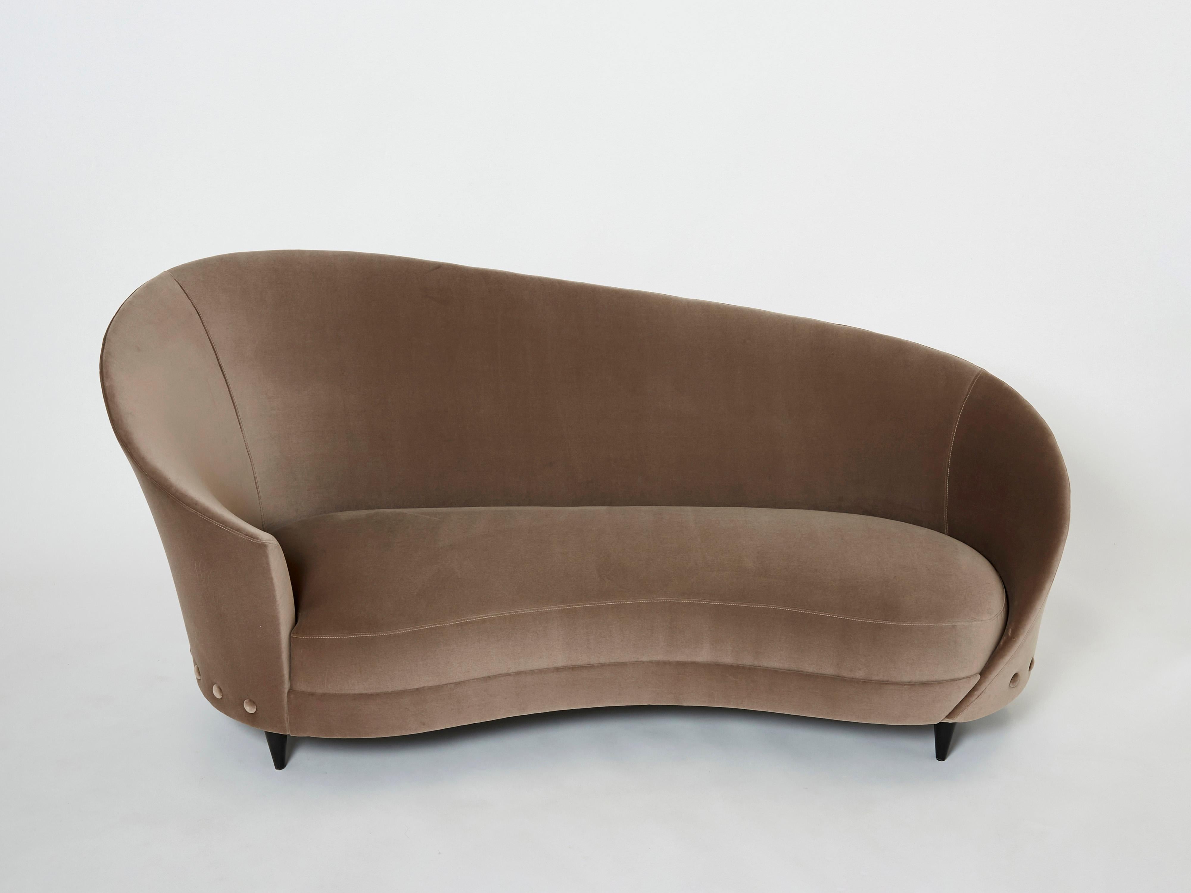 The rounded, sloped back gives this piece a jolt of Italian midcentury glamour. Designed by Federico Munari in Italy in the 1960s, the sofa seems to belong in some glitzy boudoir. It’s been fully restored and reupholstered with a smoky taupe velvet
