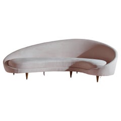 Federico Munari wood and fabric curved sofa, Italy, 1950s.