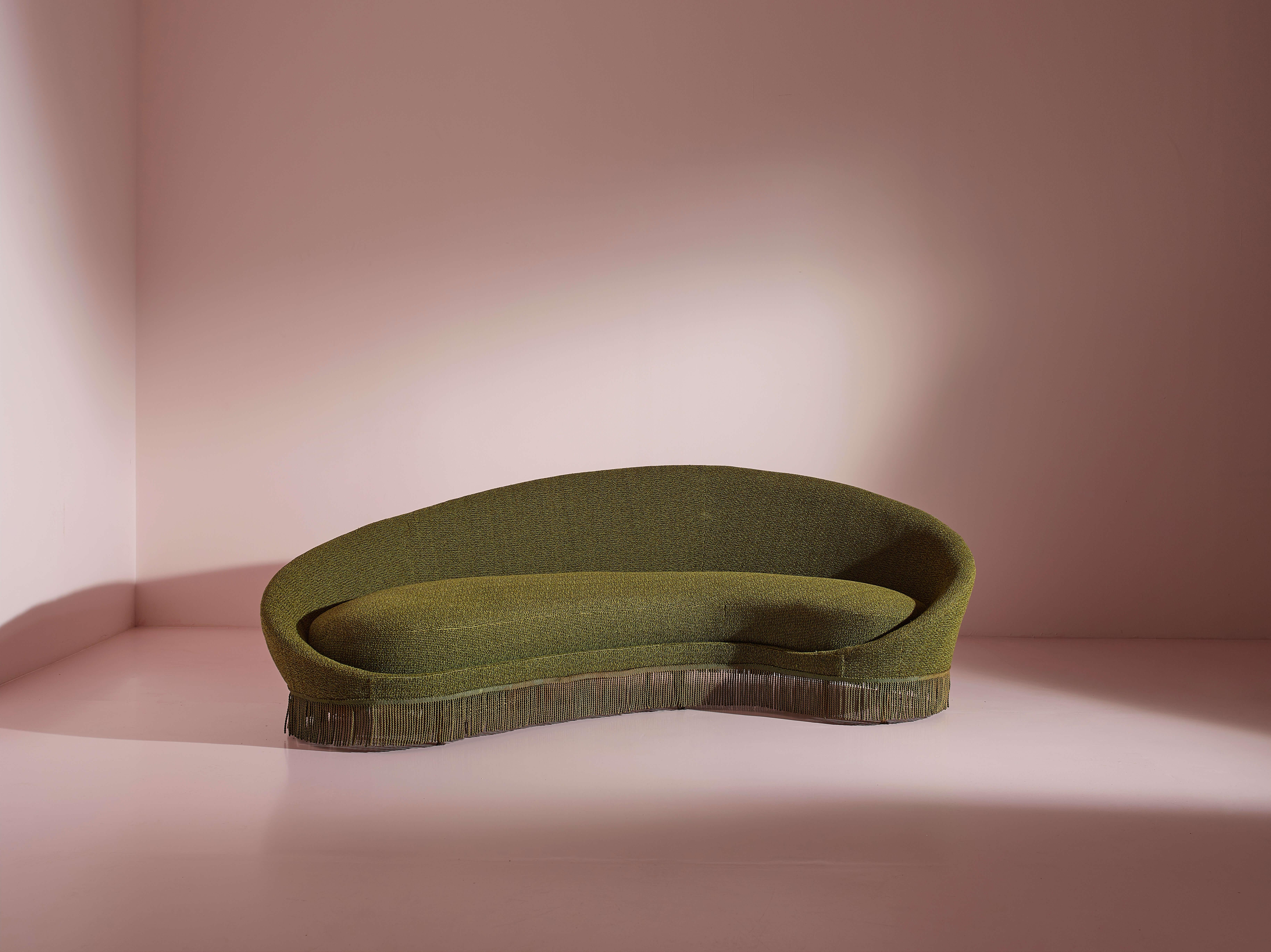 Italian-made wood and fabric sofa, designed by Federico Munari, 1950s.

This 1950s sofa, designed by Federico Munari, features elegantly curved lines and conical wooden legs, embodying a design that is both inviting and visually engaging. The subtle