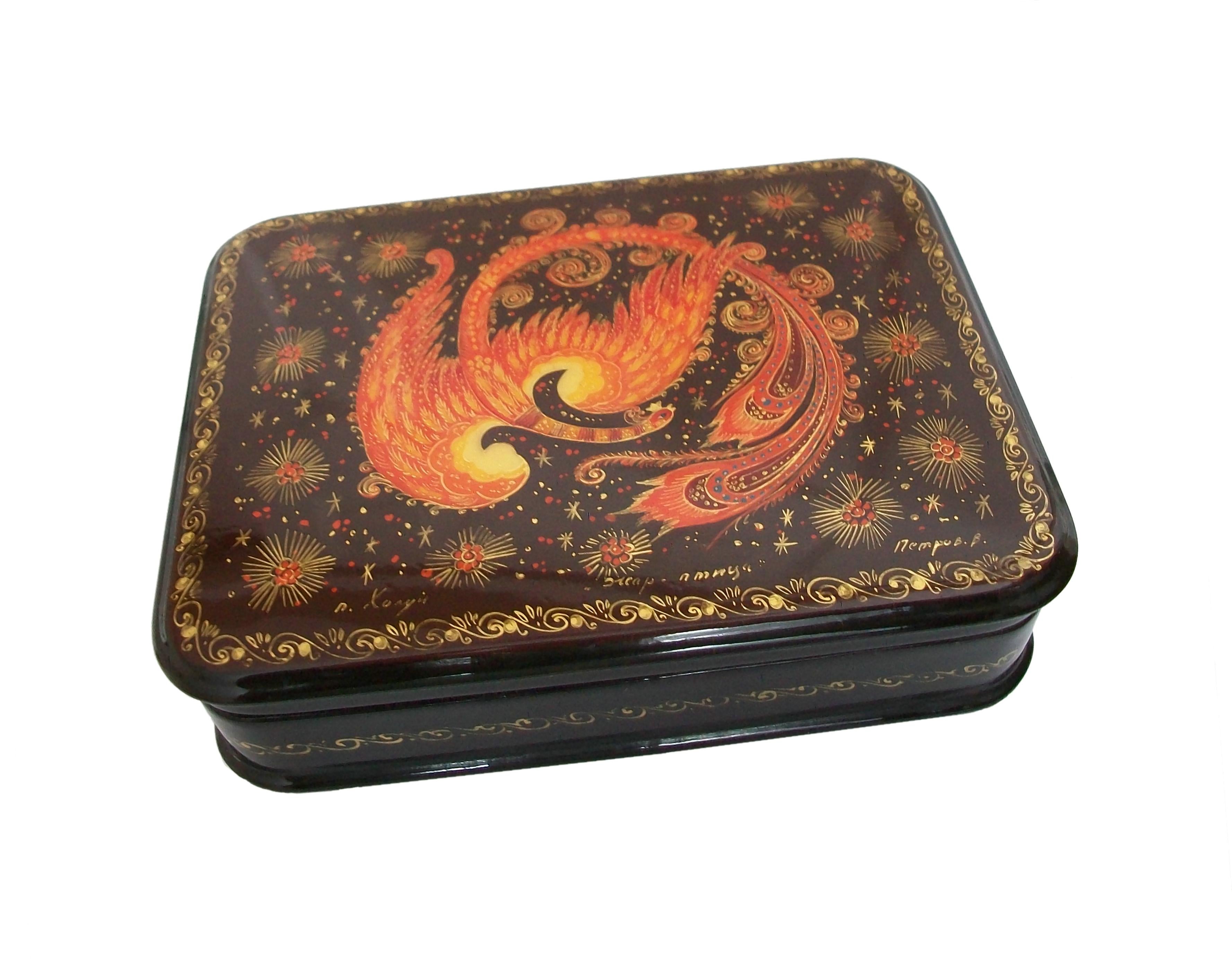 Fedoskino papier-mâché lacquer box - hand painted Phoenix set against a celestial background on brown lacquer with gilt details - black lacquer frame with gilded scrolls - hinged lid - signed - Russia - circa 1980's.

Excellent vintage condition -