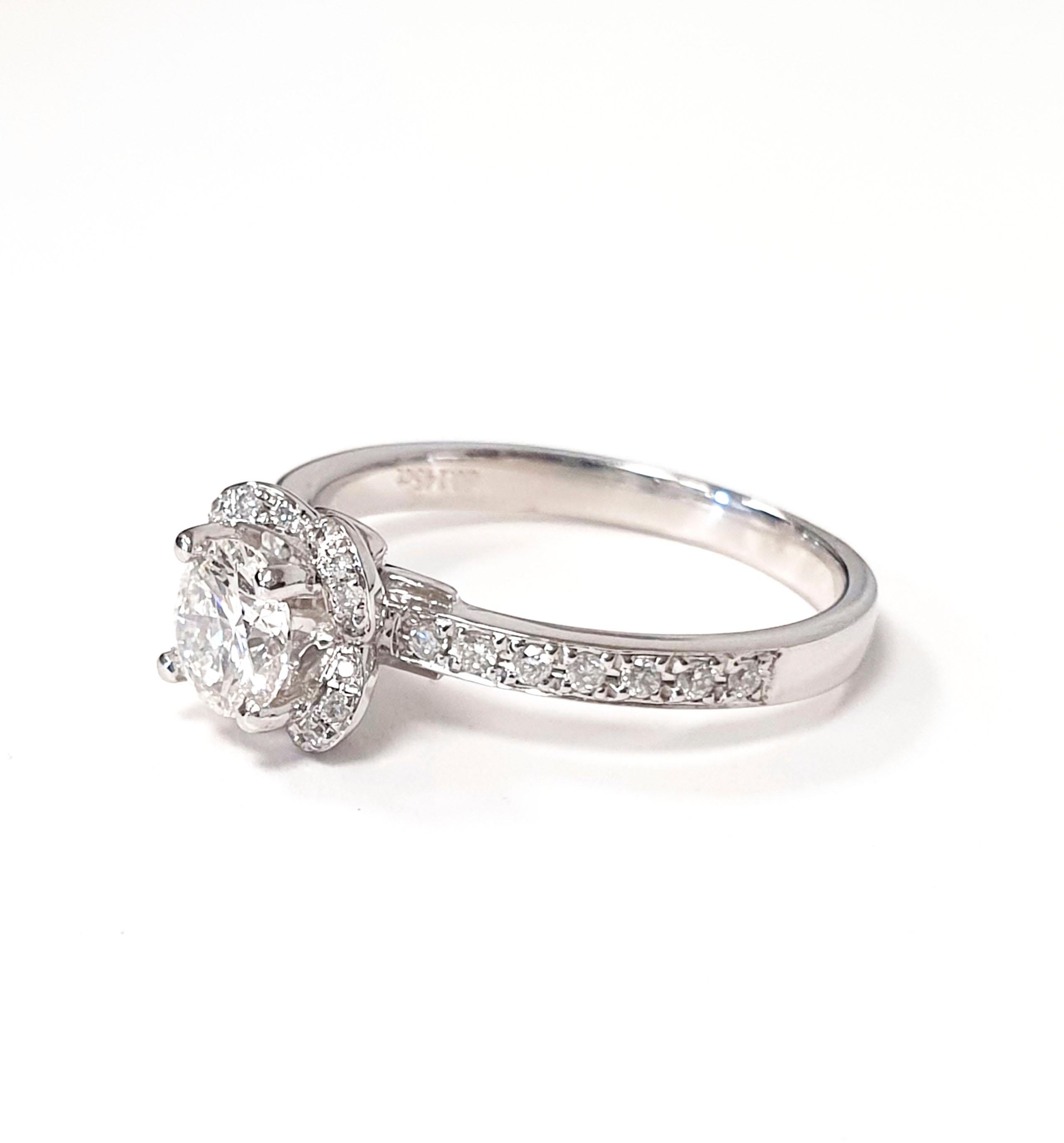 At the heart of this mesmerising ring, a luminous centre stone takes centre stage. With a weight of 0.5 carats, this brilliant diamond radiates unmatched brilliance, symbolising the unique and profound love shared between two individuals. It is