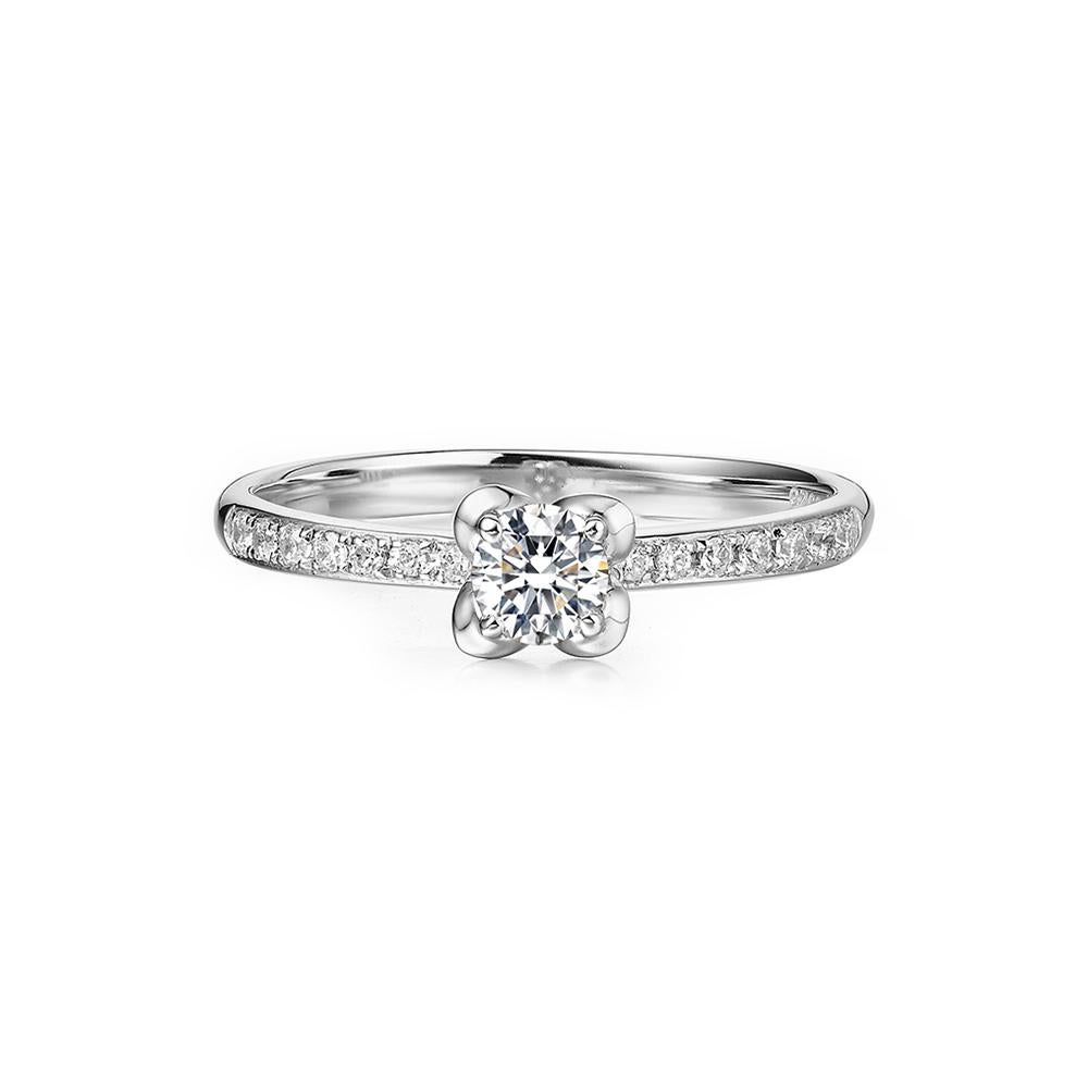 At the heart of this mesmerising ring, a luminous centre stone takes centre stage. With a weight of 0.25 carats, this brilliant diamond radiates unmatched brilliance, symbolising the unique and profound love shared between two individuals. It is