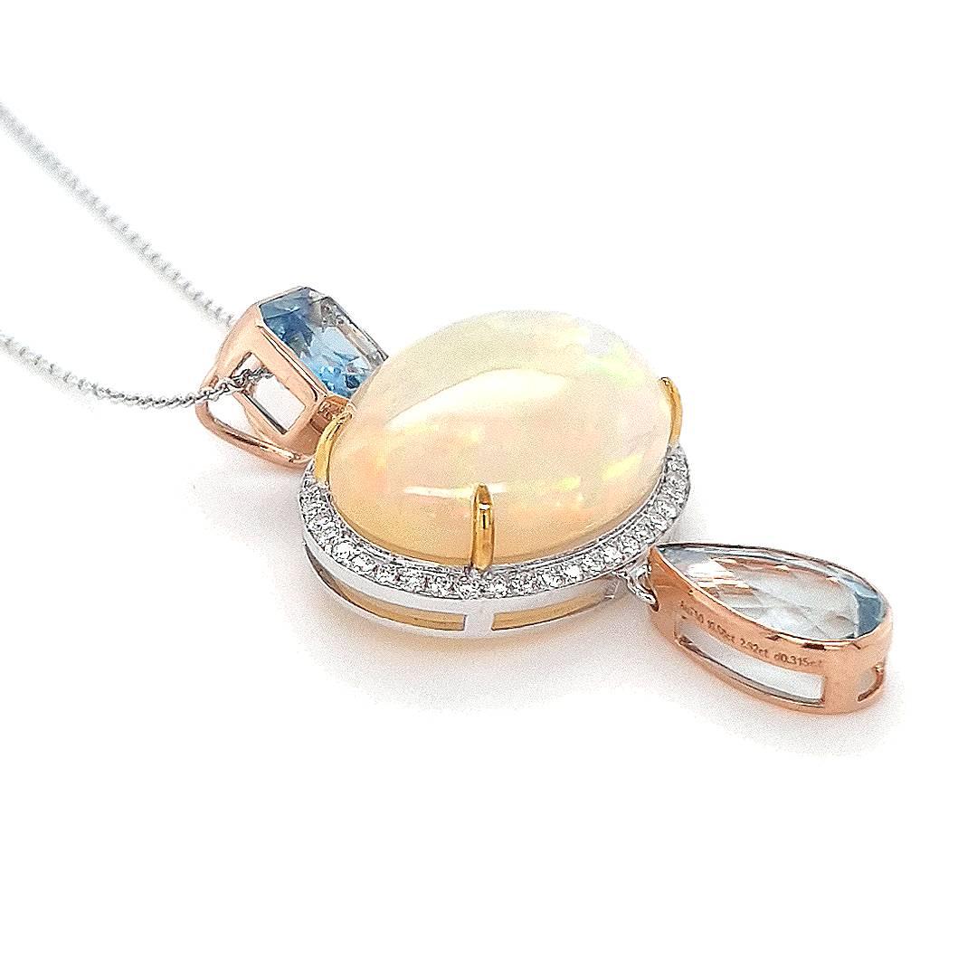 Indulge in the opulence of this two-tone 18ct gold pendant, a symphony of elegance and iridescent charm. Anchored by an octagon-cut aquamarine in an 18ct gold setting, the pendant exhibits a 10.58ct opal, ensconced in 18ct white gold and embraced by
