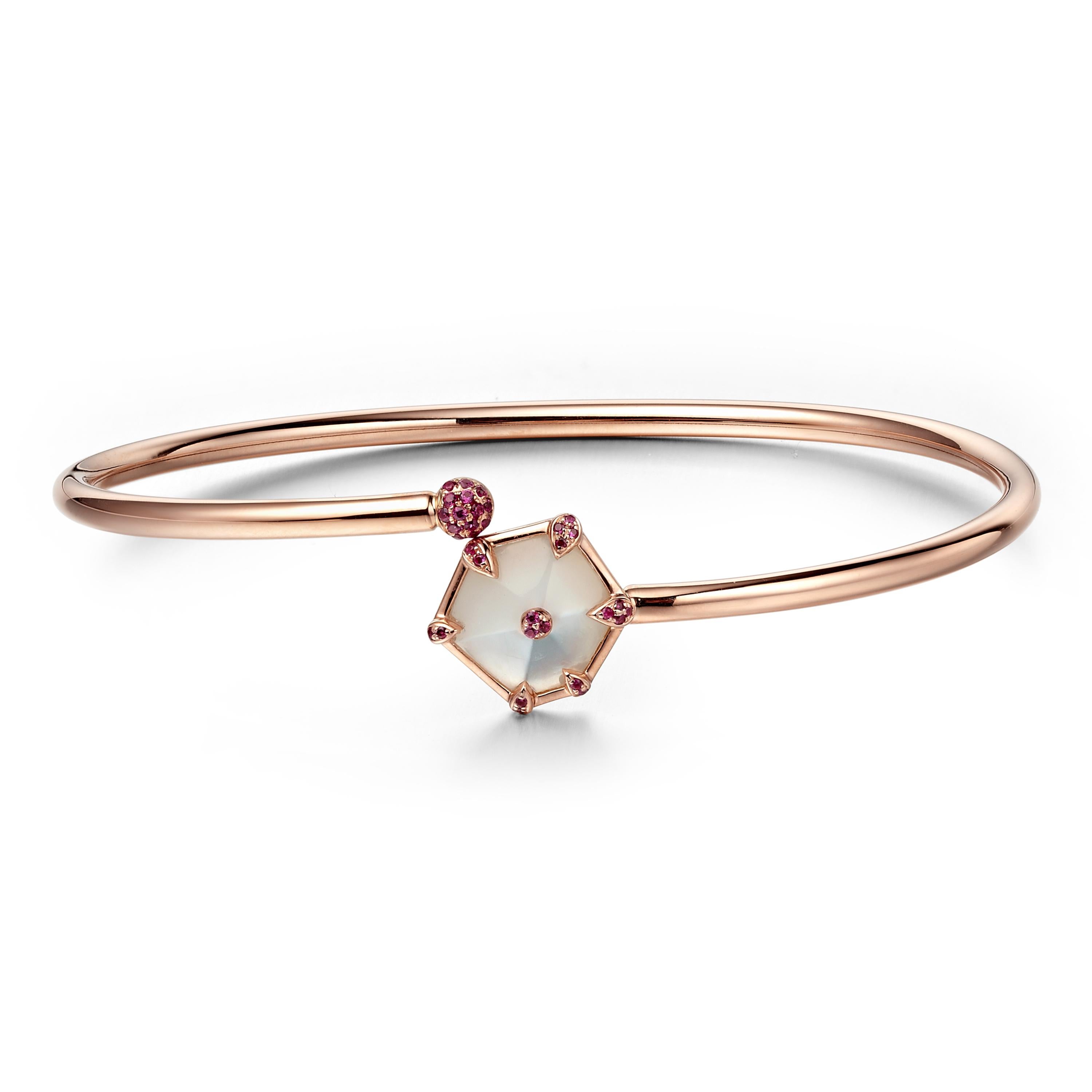 Description:
Nova kite bangle 0.108ct pink sapphires and 1.5ct mother of pearl, set in 18ct rose gold with a high polish.

Inner diameter: 55mm x 45mm (W x H)

Inspiration
The Nova Collection embodies the essence of freedom and having the courage to