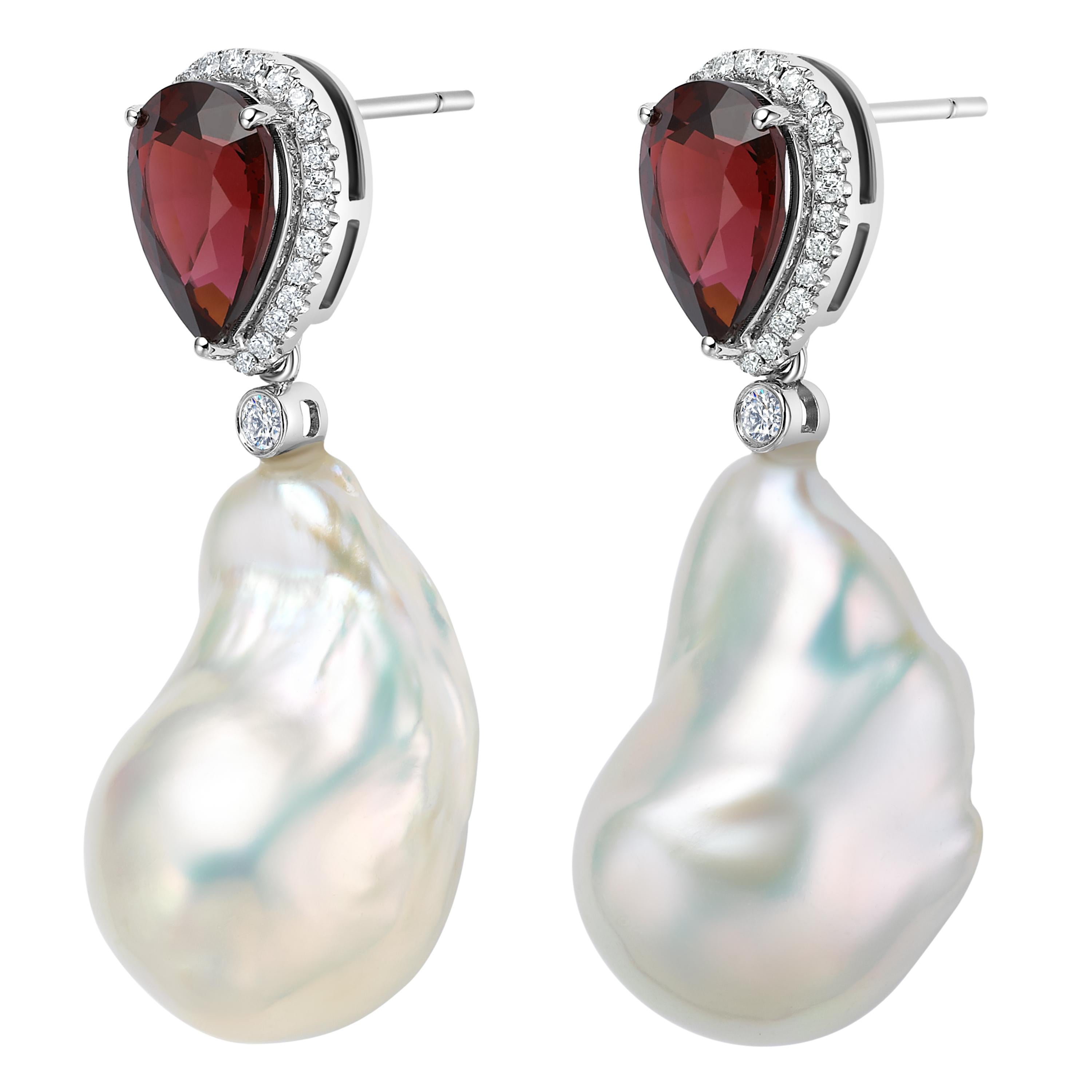 Description:
Two-piece stud and drop earrings with 3.06ct red garnet, bordering 0.285ct white diamonds and detachable baroque pearl set in 18ct white gold.

Inspiration:
Two-piece earrings encapsulating the juxtaposition of natural gemstones, which
