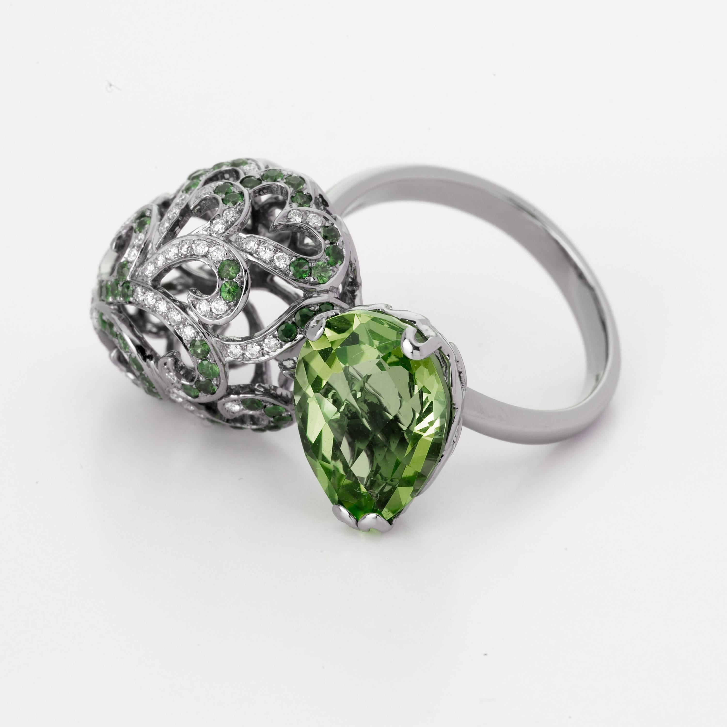 Description:
Whispering large double ring with 4.5ct green amethyst, 0.3ct white diamonds and 0.2ct green garnets, set in black rhodium plate on 18ct white gold.

Inspiration:
Emulating femininity and glamour, the Whispering collection is full of