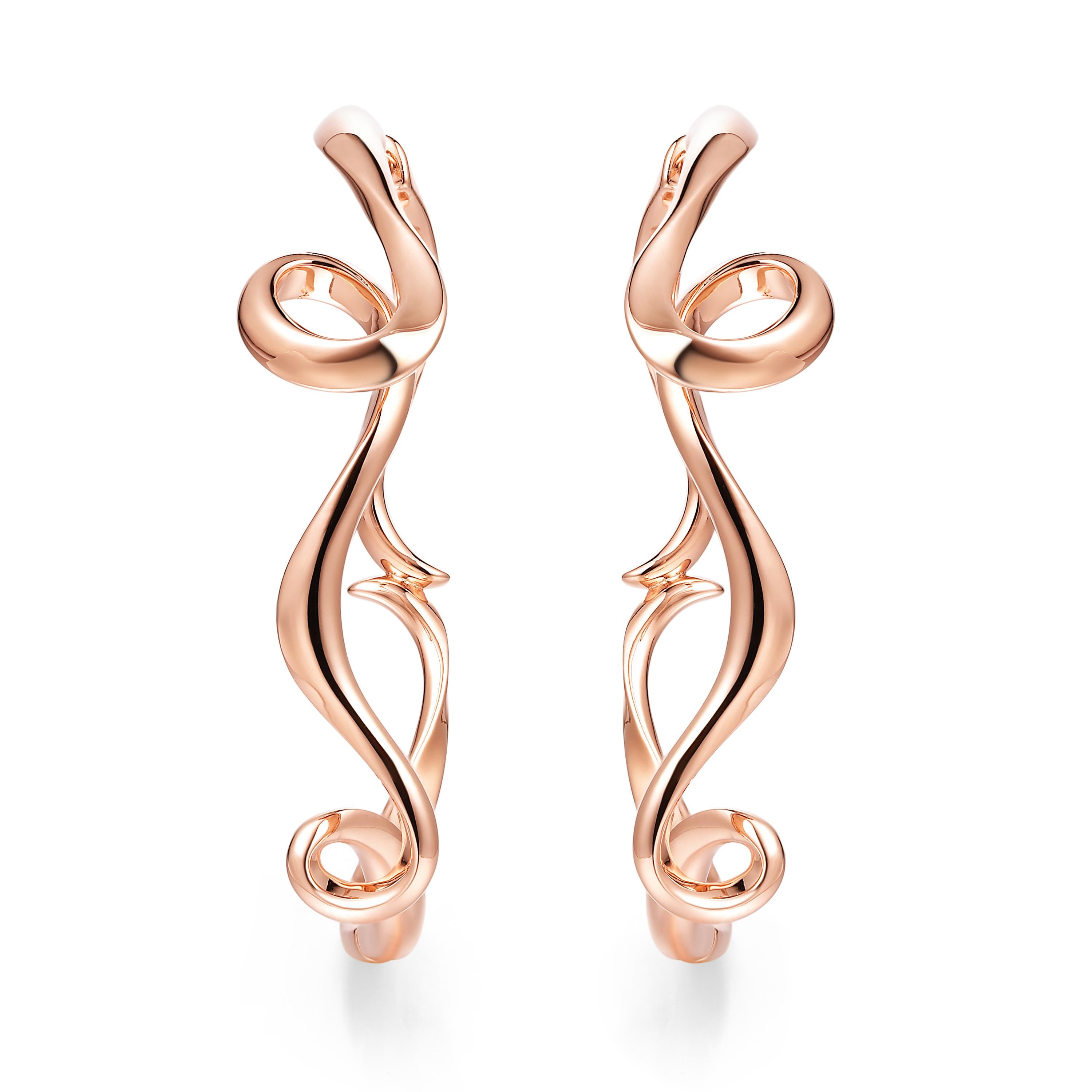 Description:
Serenity large hoop earrings in 18ct rose gold plated on sterling silver.

Inspiration:
Serenity is a collection in sterling silver, inspired by the flow and curves of the smoke of incense. Promoting a calm and peaceful environment,