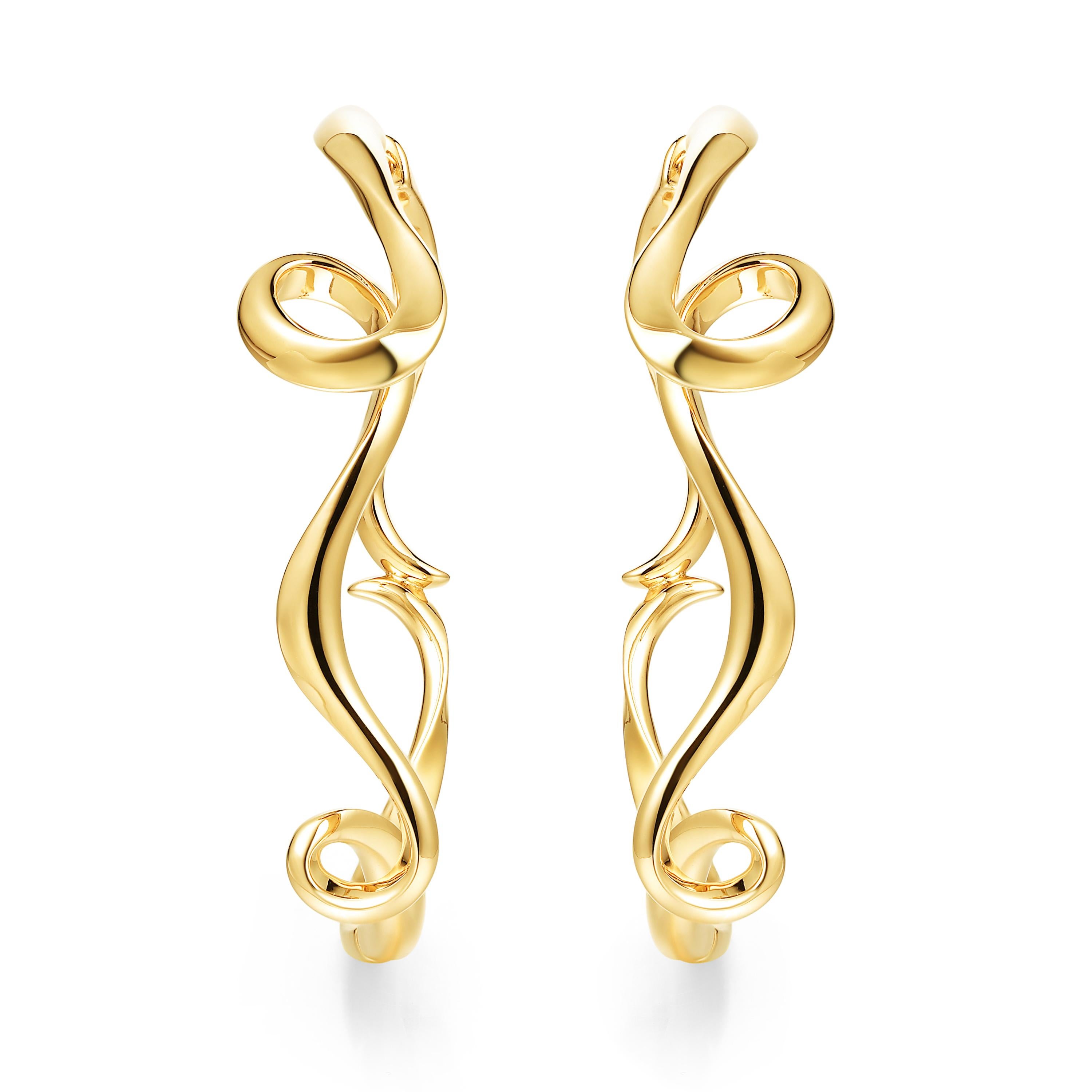 Description:
Serenity large hoop earrings in 18ct yellow gold plated on sterling silver.

Inspiration:
Serenity is a collection in sterling silver, inspired by the flow and curves of the smoke of incense. Promoting a calm and peaceful environment,