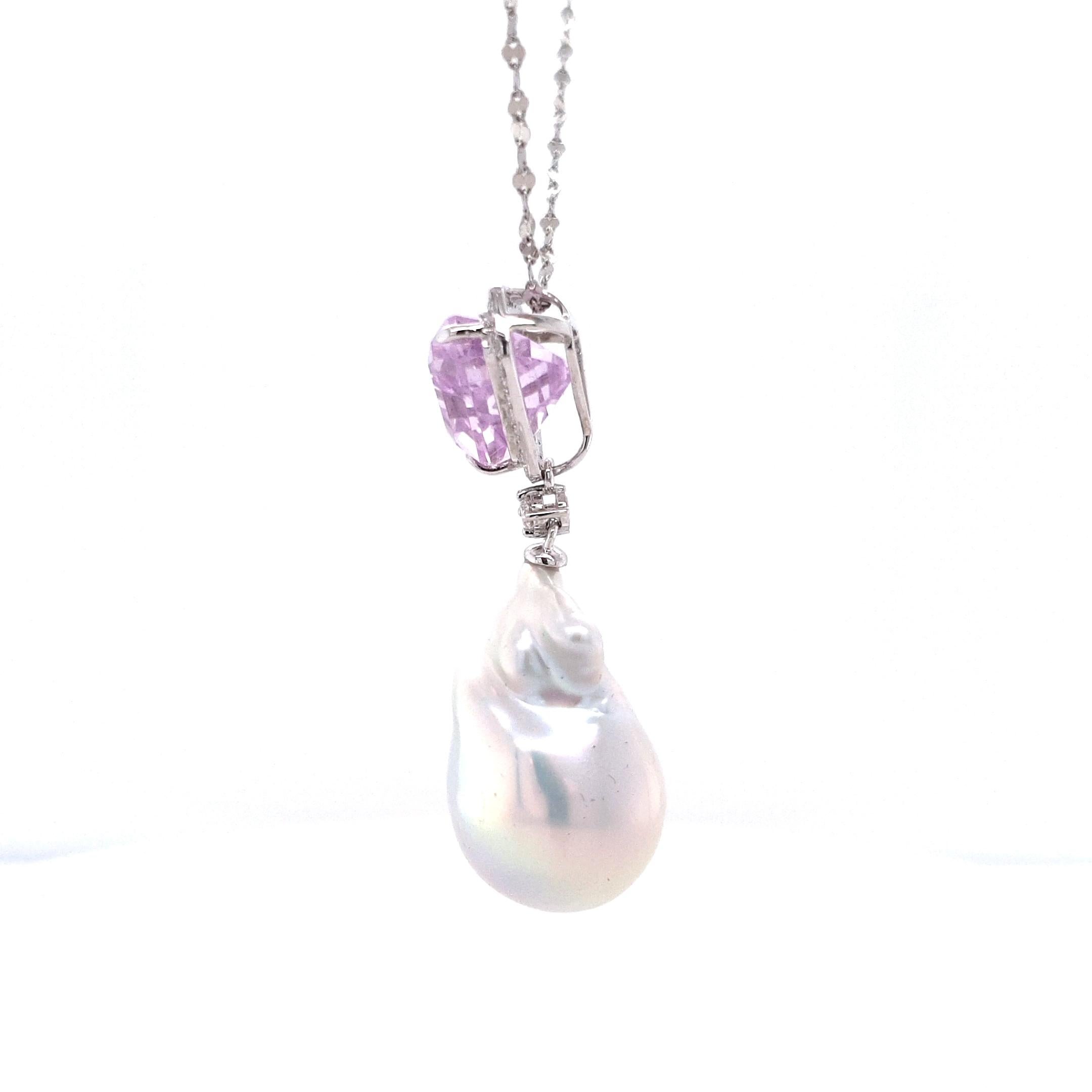 Une kunzite rose pâle, délicatement facettée et sertie en platine, forme le cœur de ce pendentif - sa douce luminosité est encadrée par un halo de diamants taillés en brillant qui lui confèrent une clarté éclatante. En dessous est suspendue une