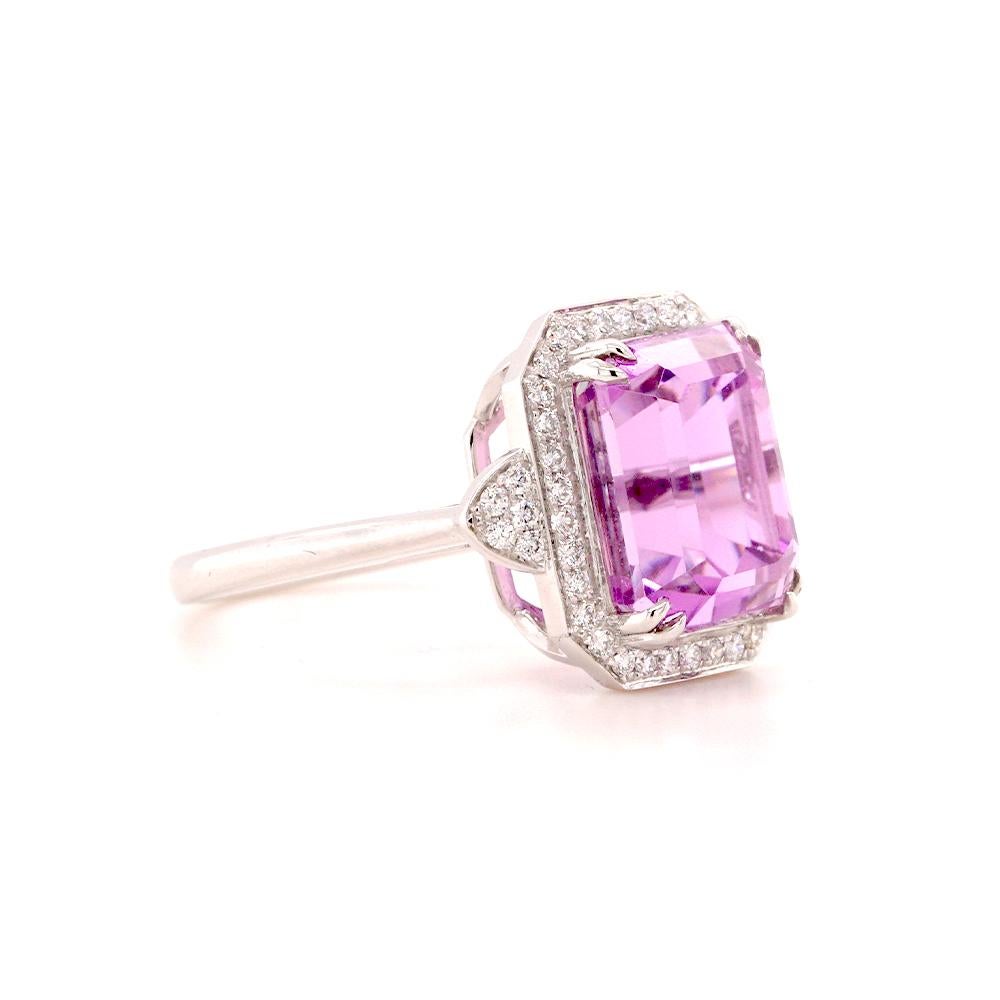 Exquisitely crafted in 18ct white gold, this breathtaking ring showcases a vivid 9.44ct step-cut emerald kunzite, captivating with its enchanting pink-lavender hue and exceptional brilliance. The elegant step-cut enhances the gemstone's natural